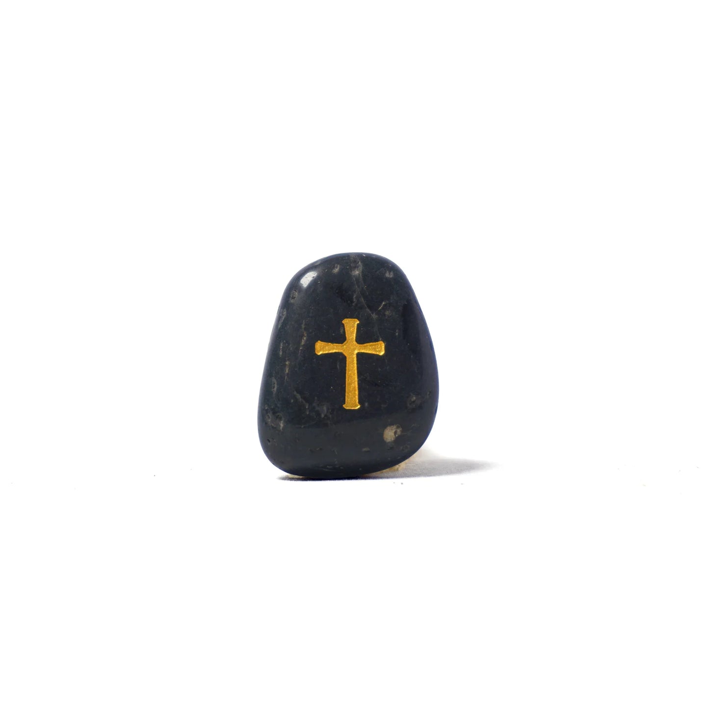 Black stone with a gold cross on a white background