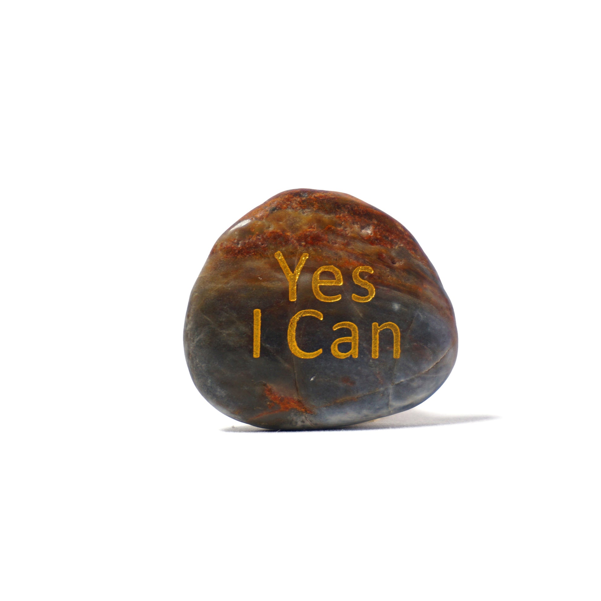 Decorative stone with 'Yes I Can' text on a white background