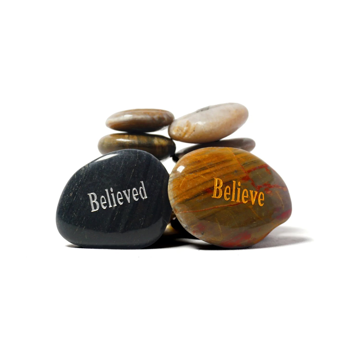 Stack of stones with 'Believed' and 'Believe' text on a white background