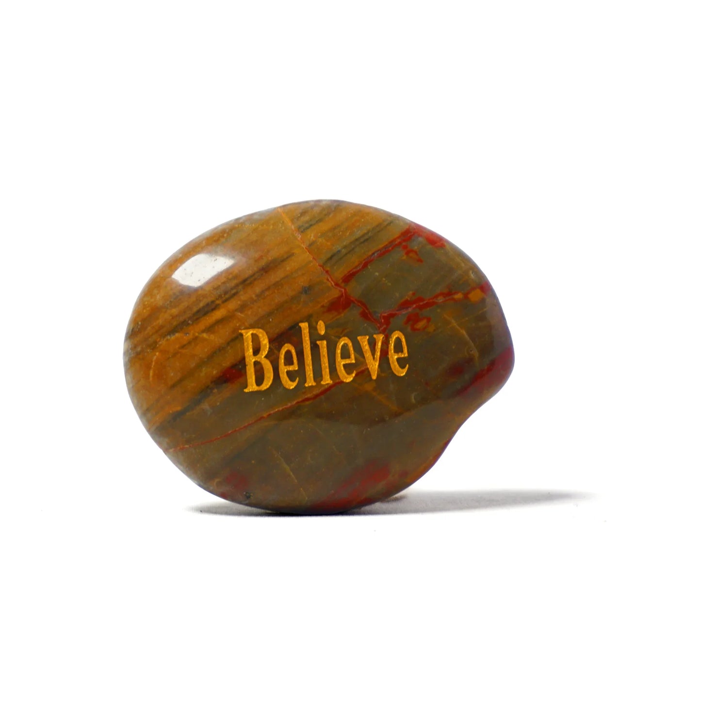 Decorative stone with 'Believe' engraved on a white background
