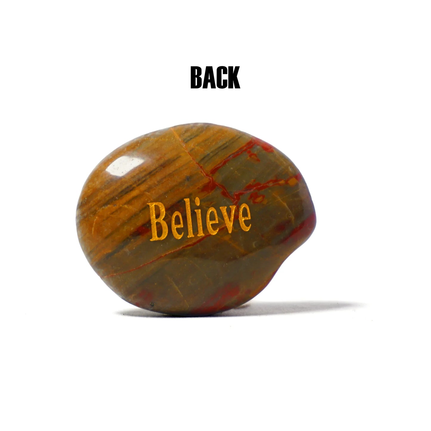 Decorative stone with 'Believe' engraved on a white background