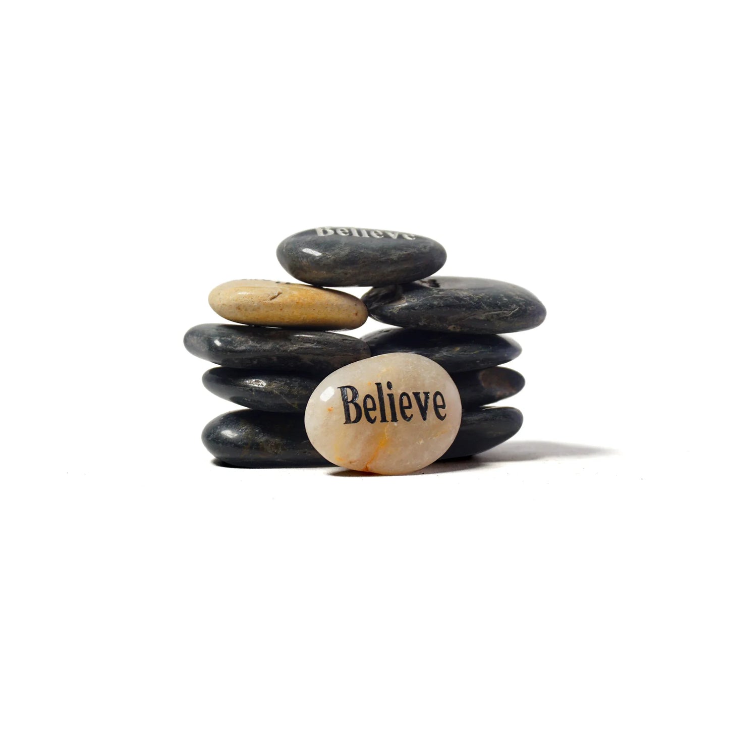Stack of stones with a smaller stone on top featuring the word 'Believe'