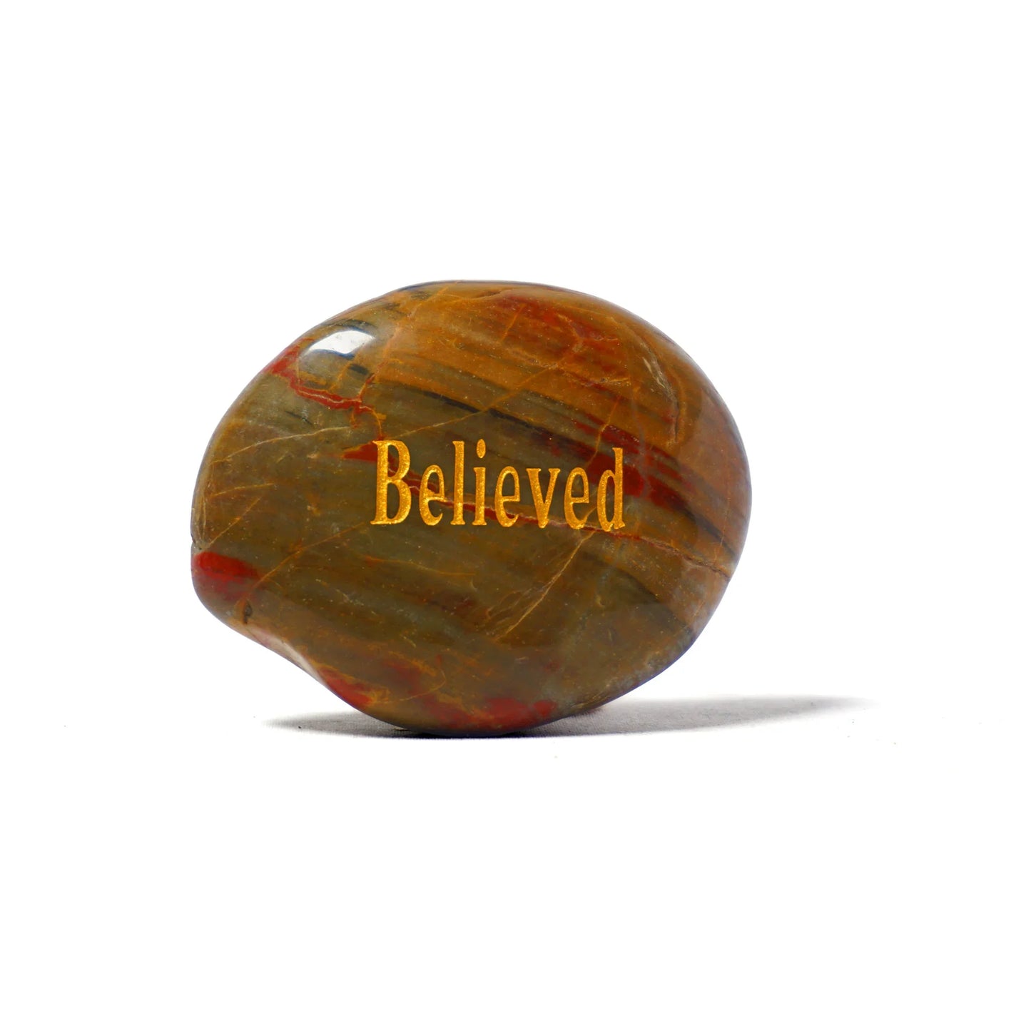 Marbled stone with 'Believed' text on a white background
