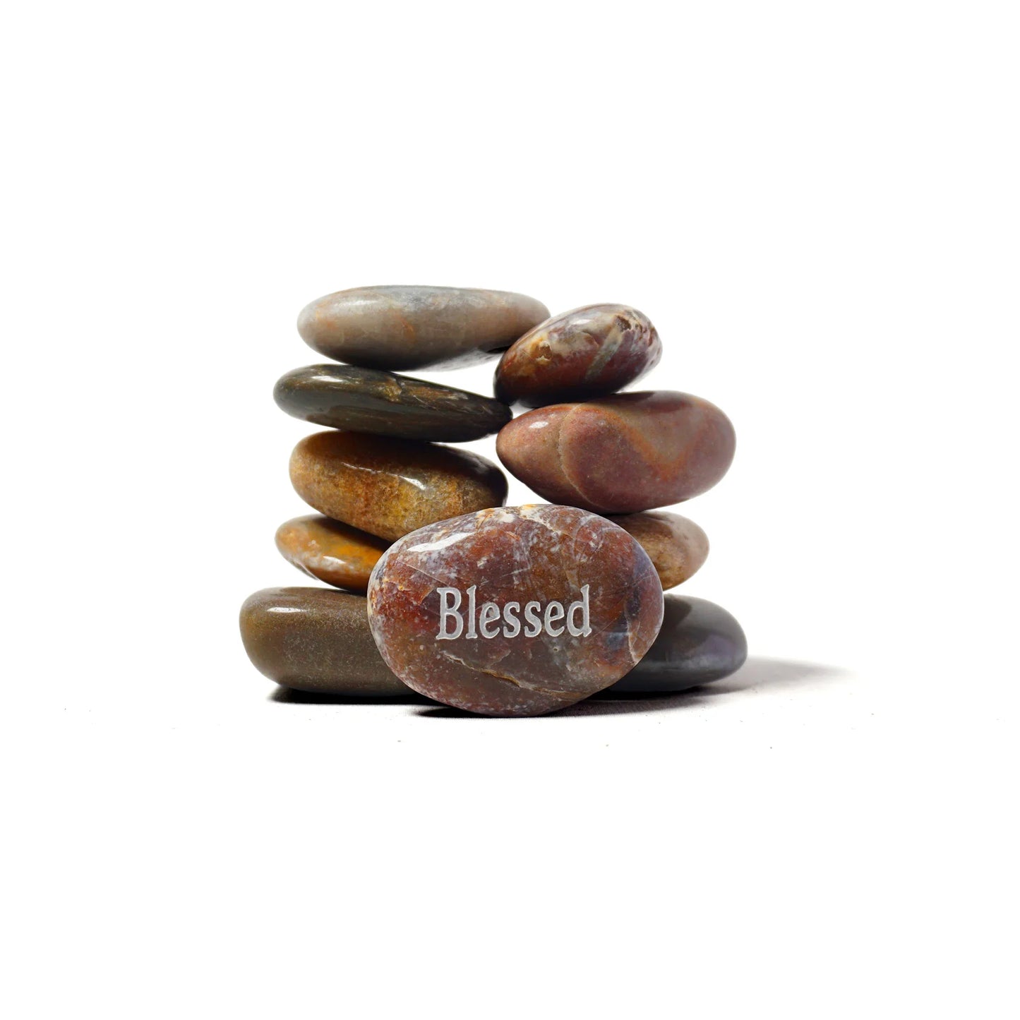 Stack of stones with a 'Blessed' stone on a white background