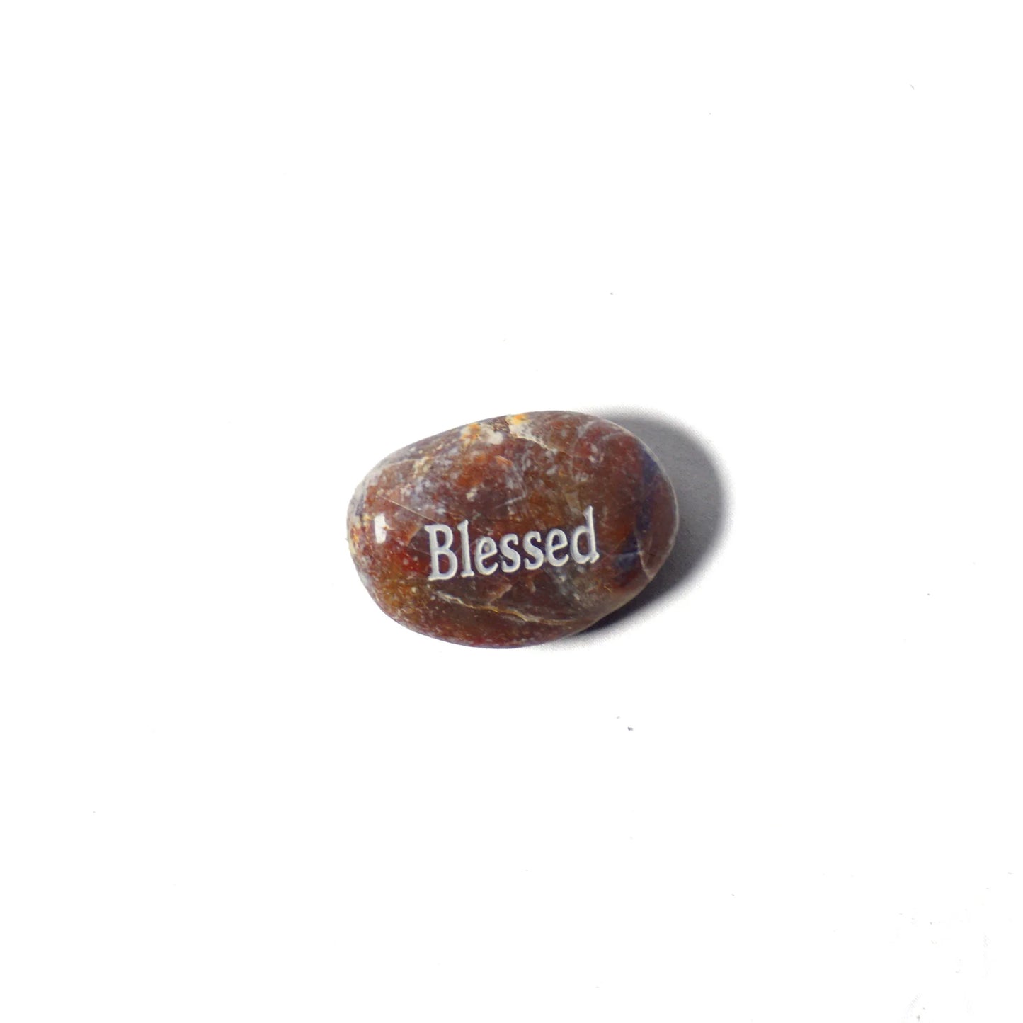 Brown stone with 'Blessed' engraved on a white background