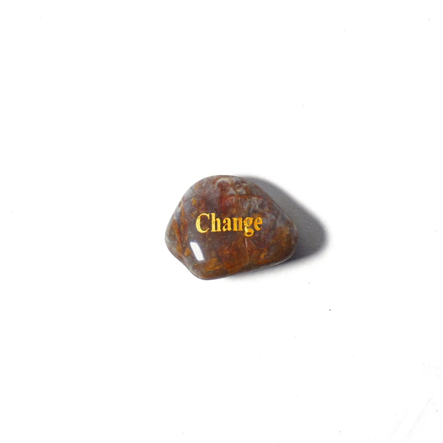 Brown stone with 'Change' engraved on a white background