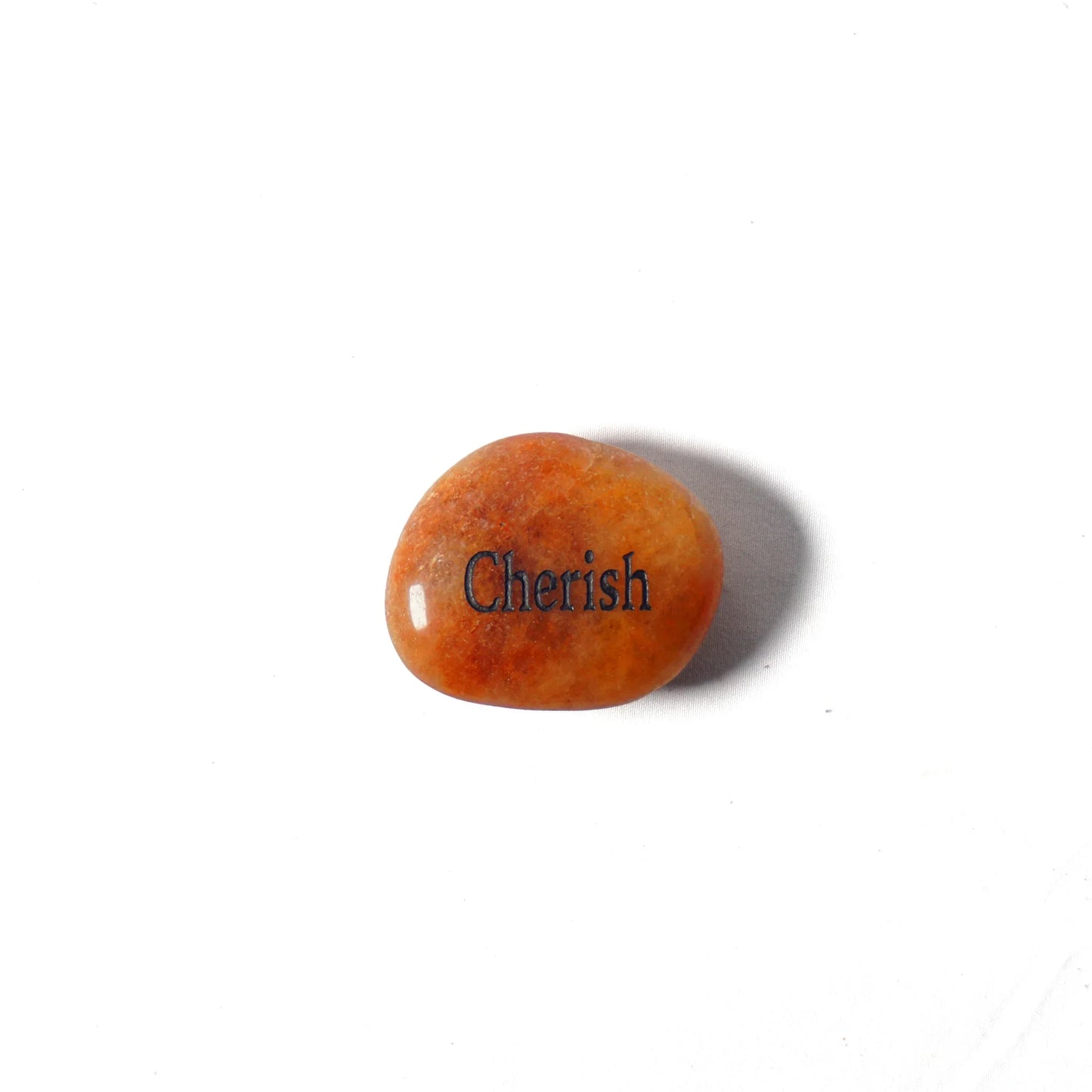 Orange stone with 'Cherish' engraved on a white background