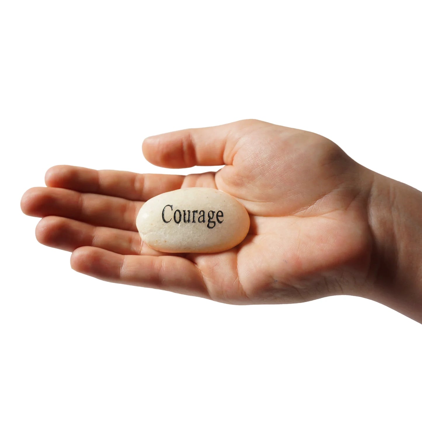 Hand holding a stone with 'Courage' engraved on it against a white background