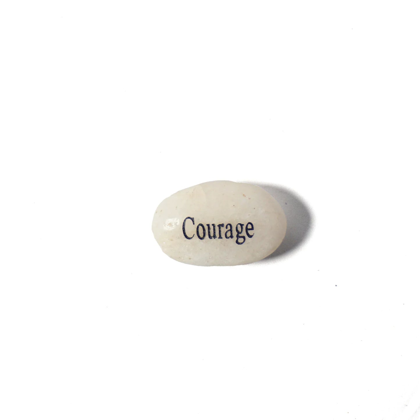 Small stone with the word 'Courage' engraved on a white background