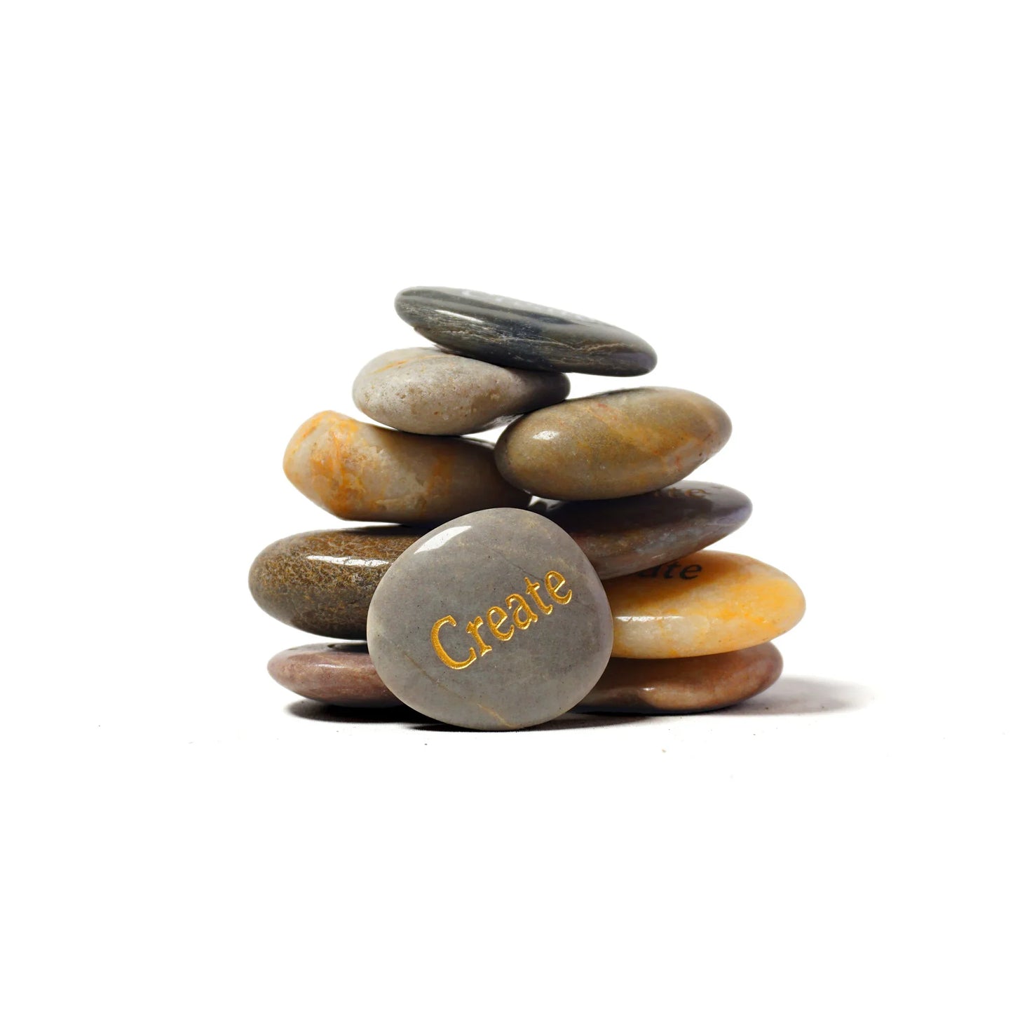 Stack of stones with 'Create' engraved on one stone against a white background