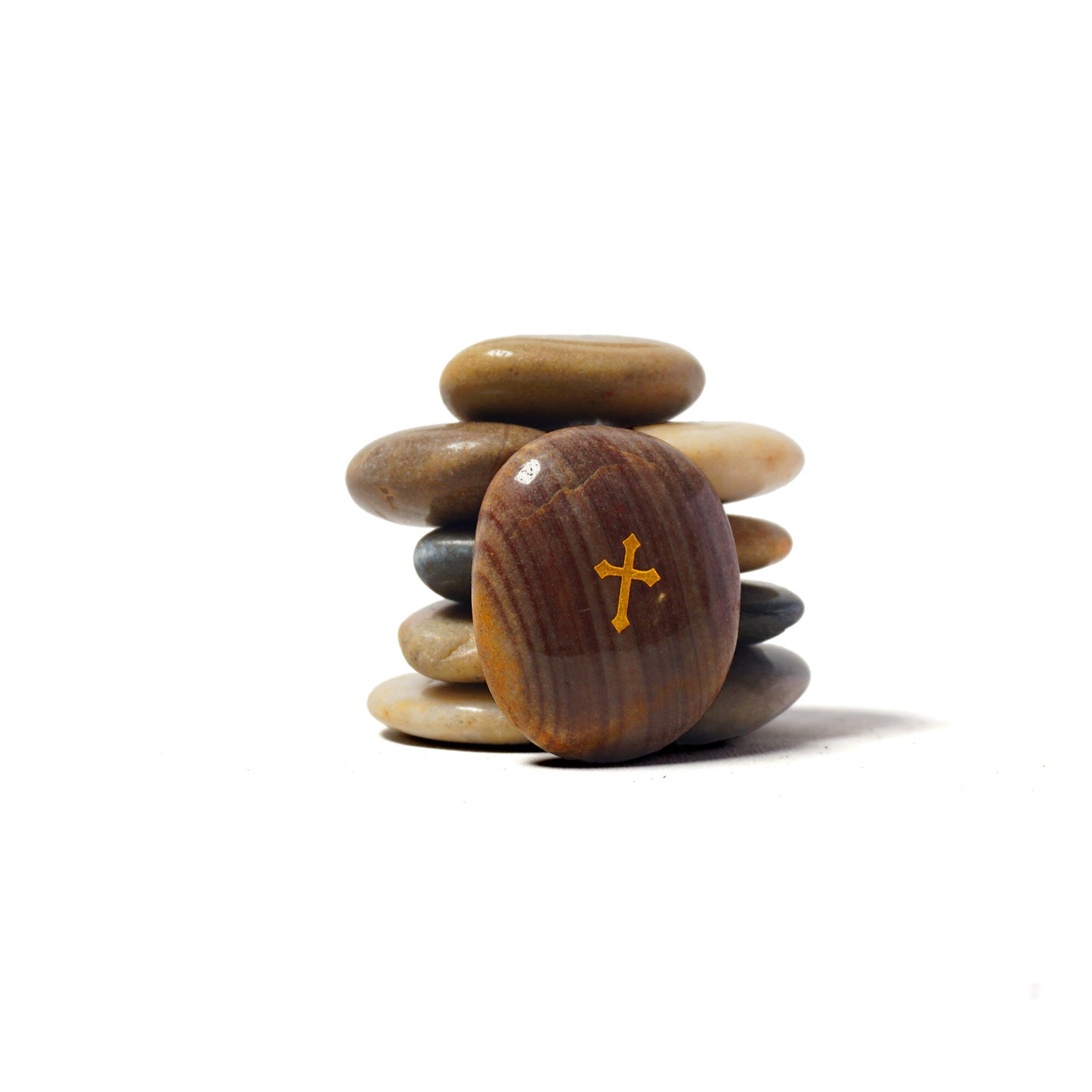 Stack of stones with a cross symbol on a white background