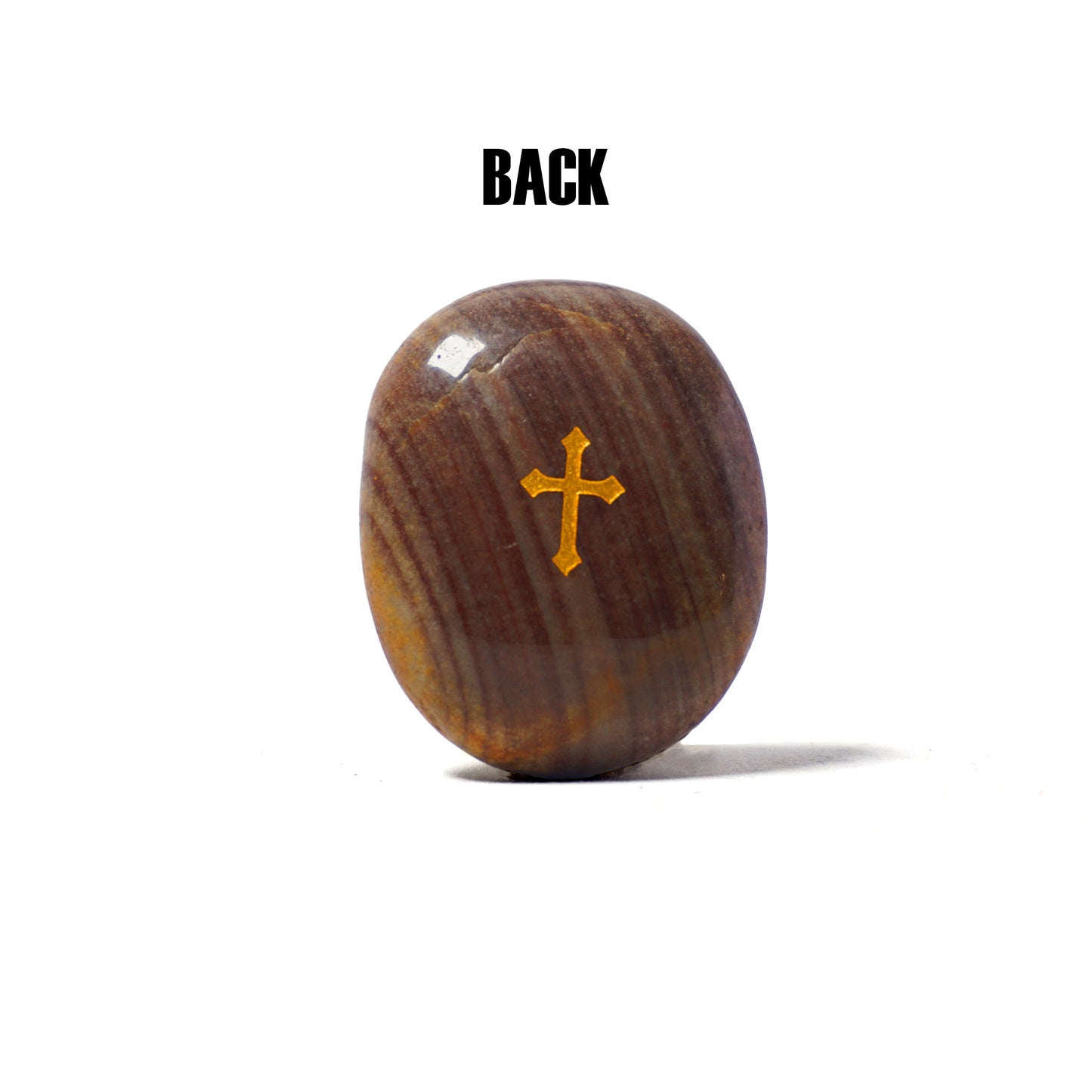 Brown stone with a gold cross on a white background