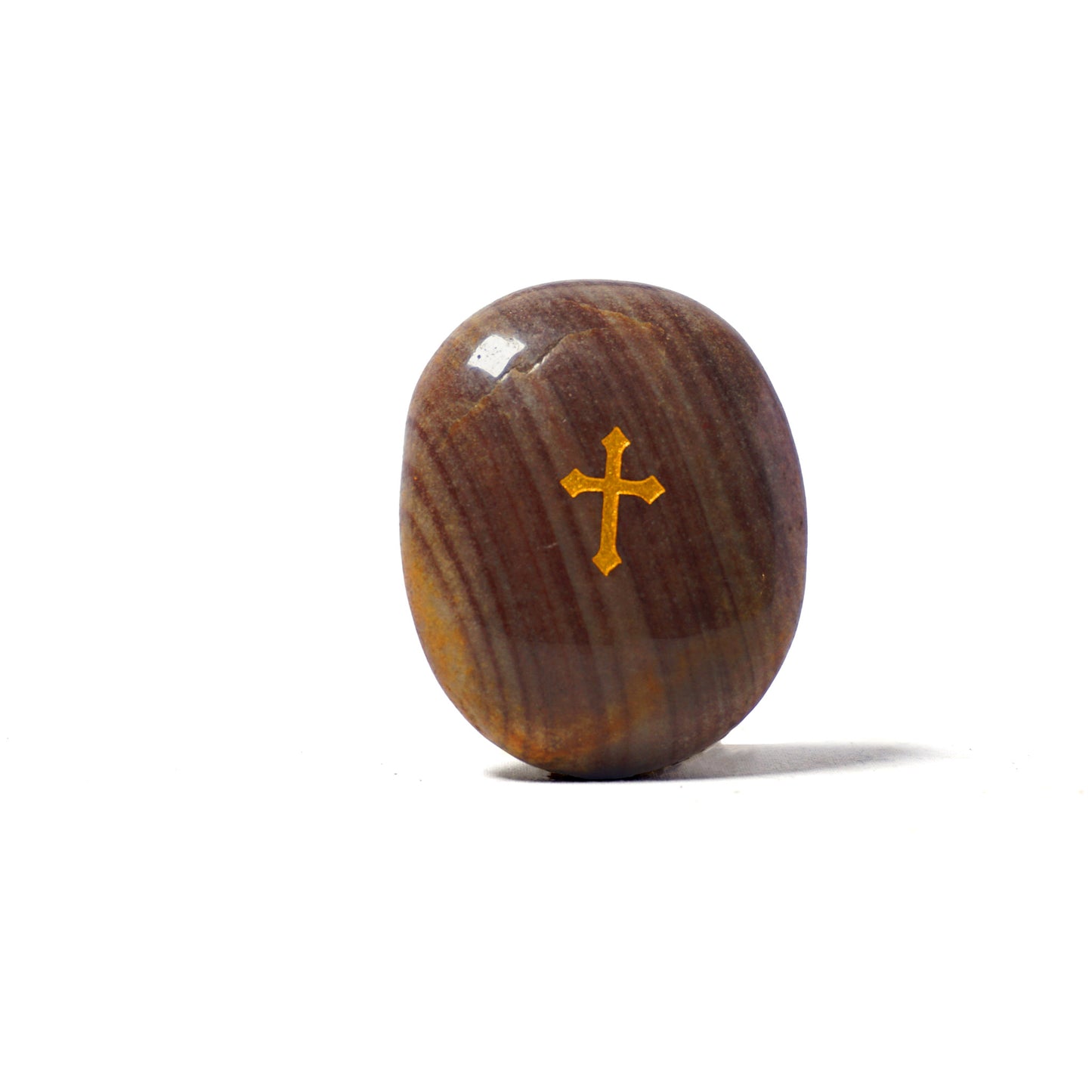 Brown stone with a gold cross on a white background