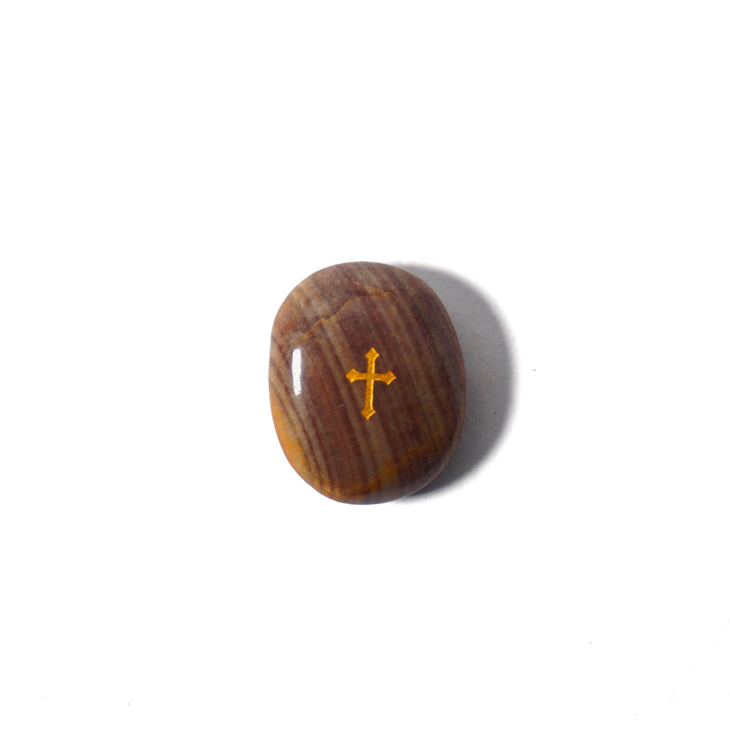 Brown stone with a gold cross on a white background