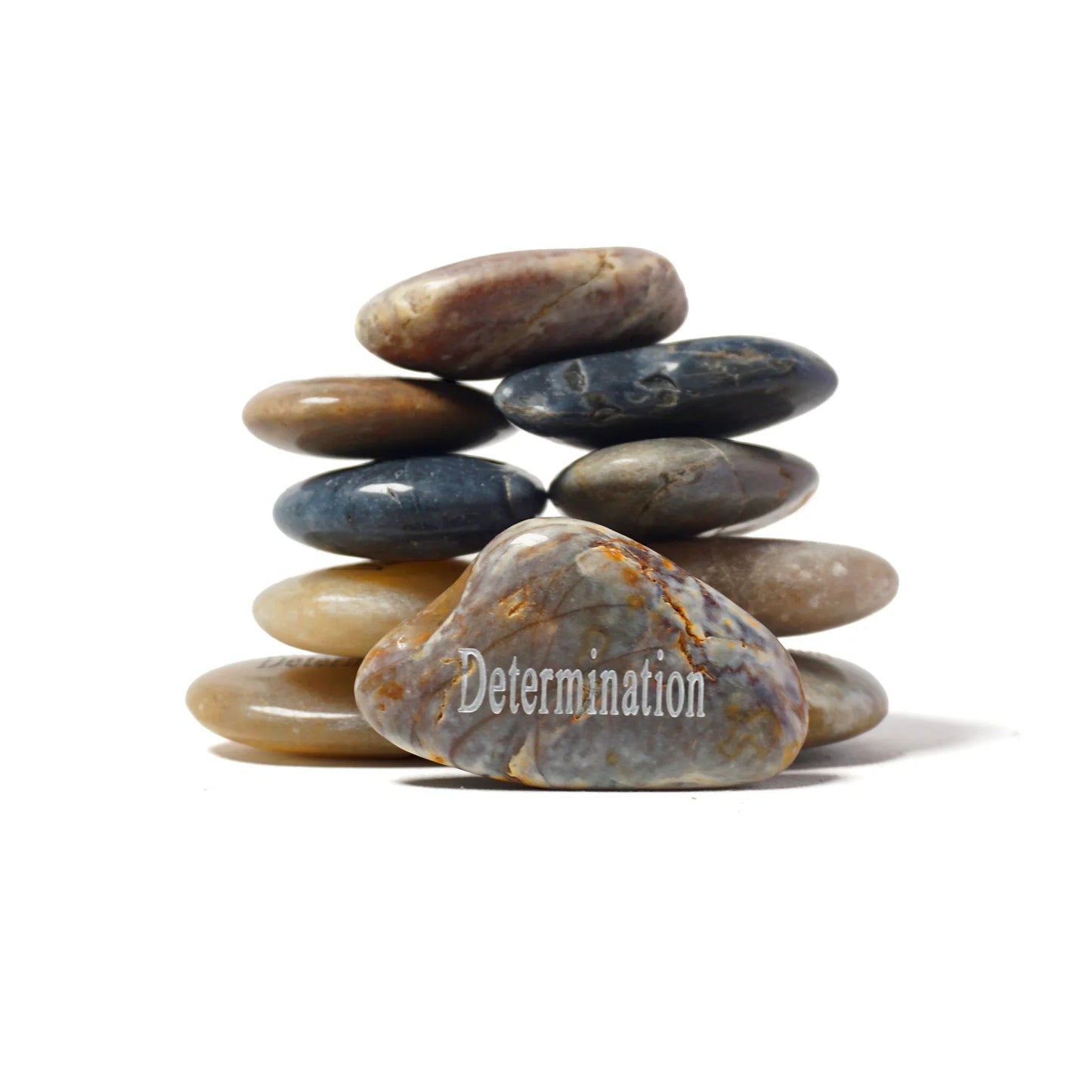 Stack of stones with 'Determination' text on a white background
