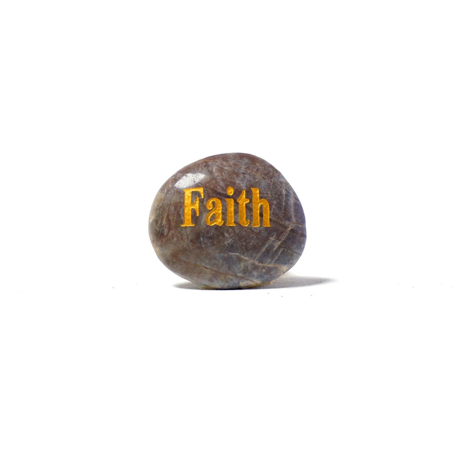 Rock with 'Faith' engraved on a white background