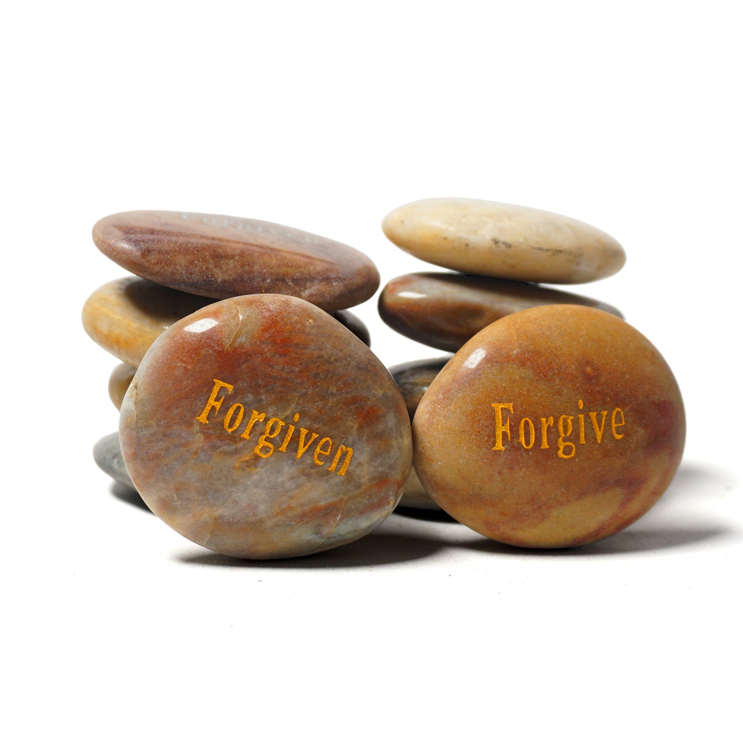 Stack of stones with 'Forgiven' and 'Forgive' engraved on a white background