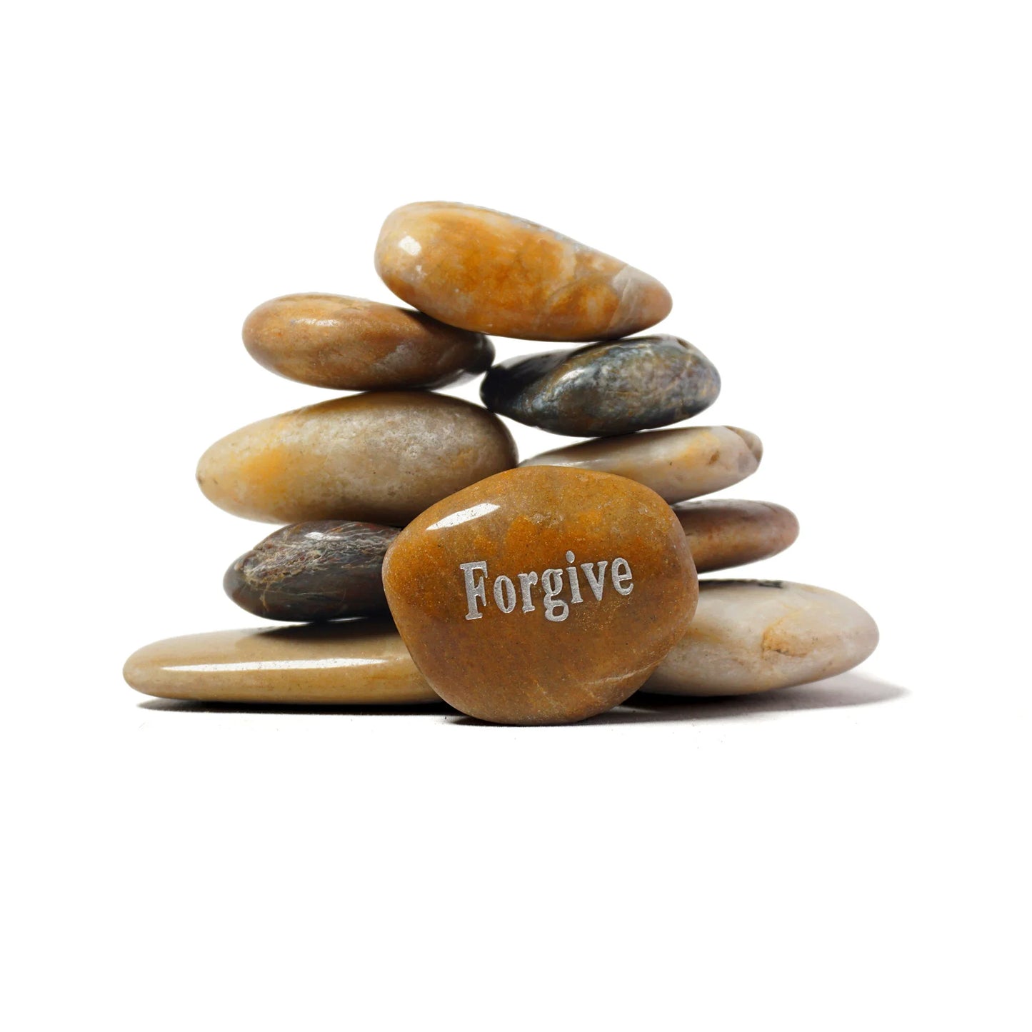Stack of stones with 'Forgive' engraved on one stone against a white background