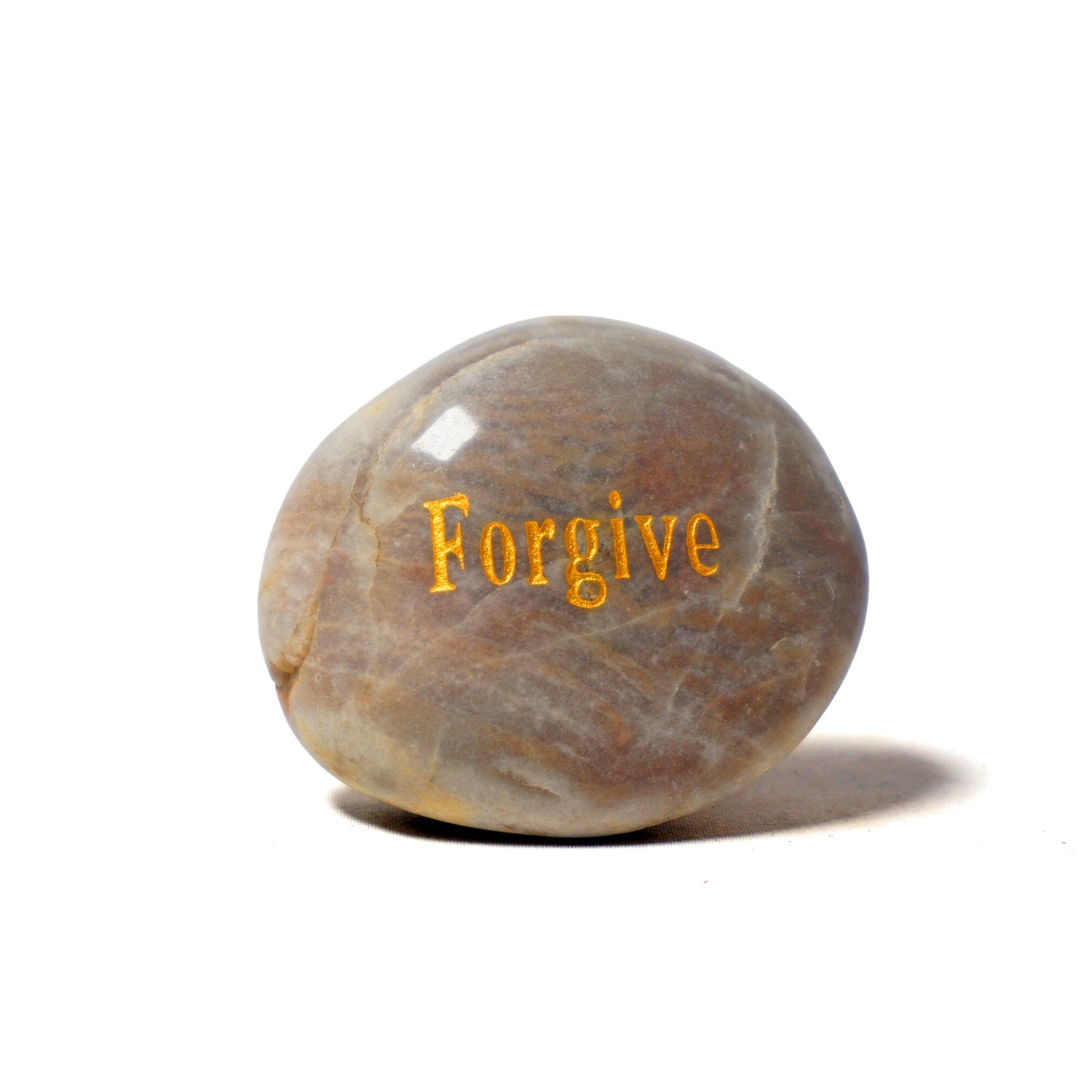 Round stone with 'Forgive' engraved on a white background