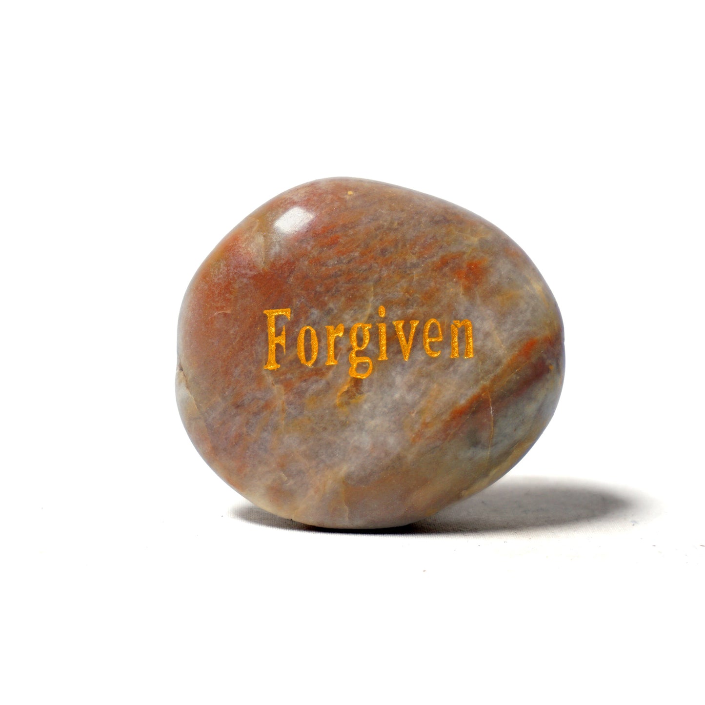 Brown stone with 'Forgiven' engraved on a white background