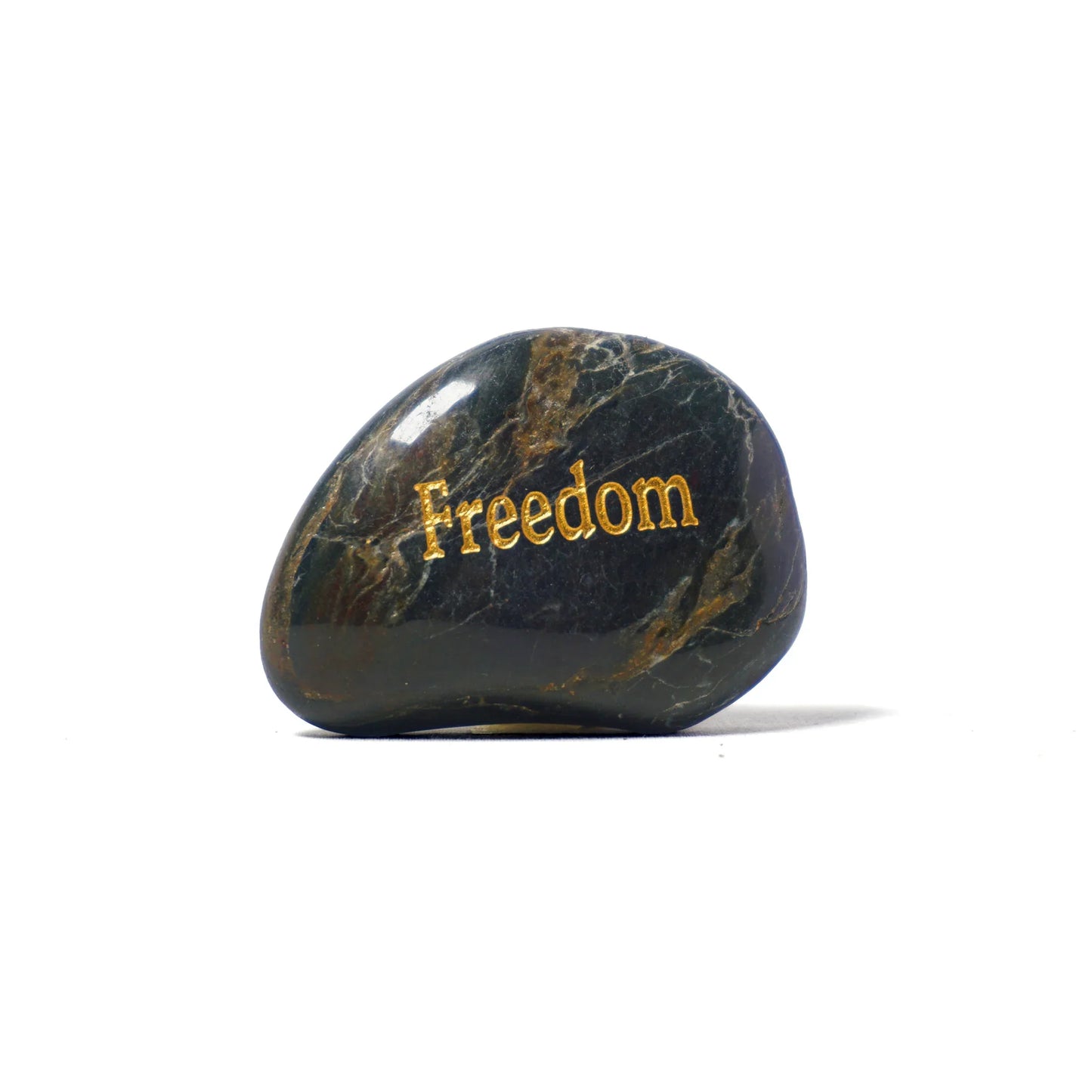 Black stone with 'Freedom' engraved in gold on a white background