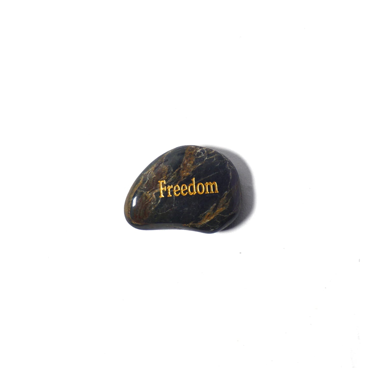 Black stone with 'Freedom' engraved on a white background