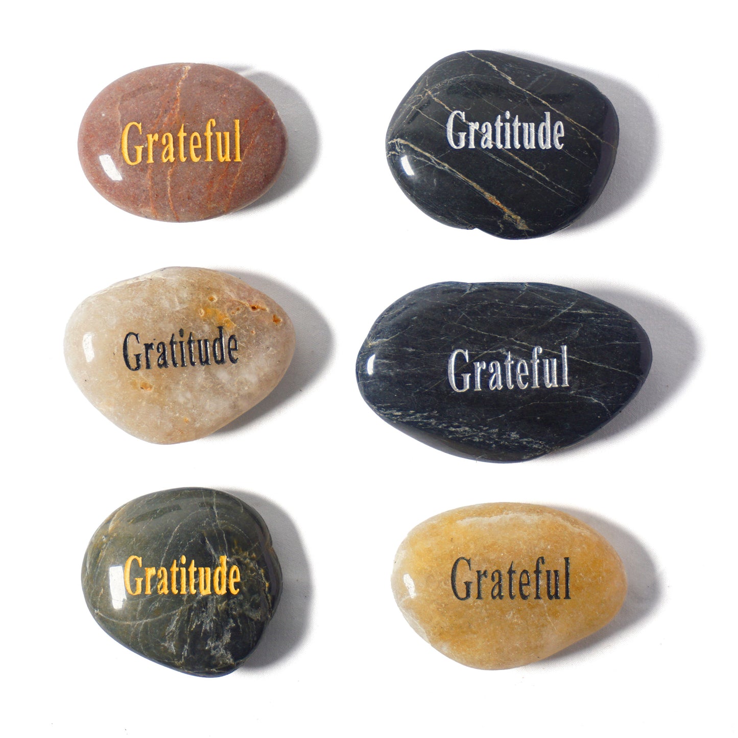 Set of six stones with 'Gratitude' inscribed on them, placed on a white background.