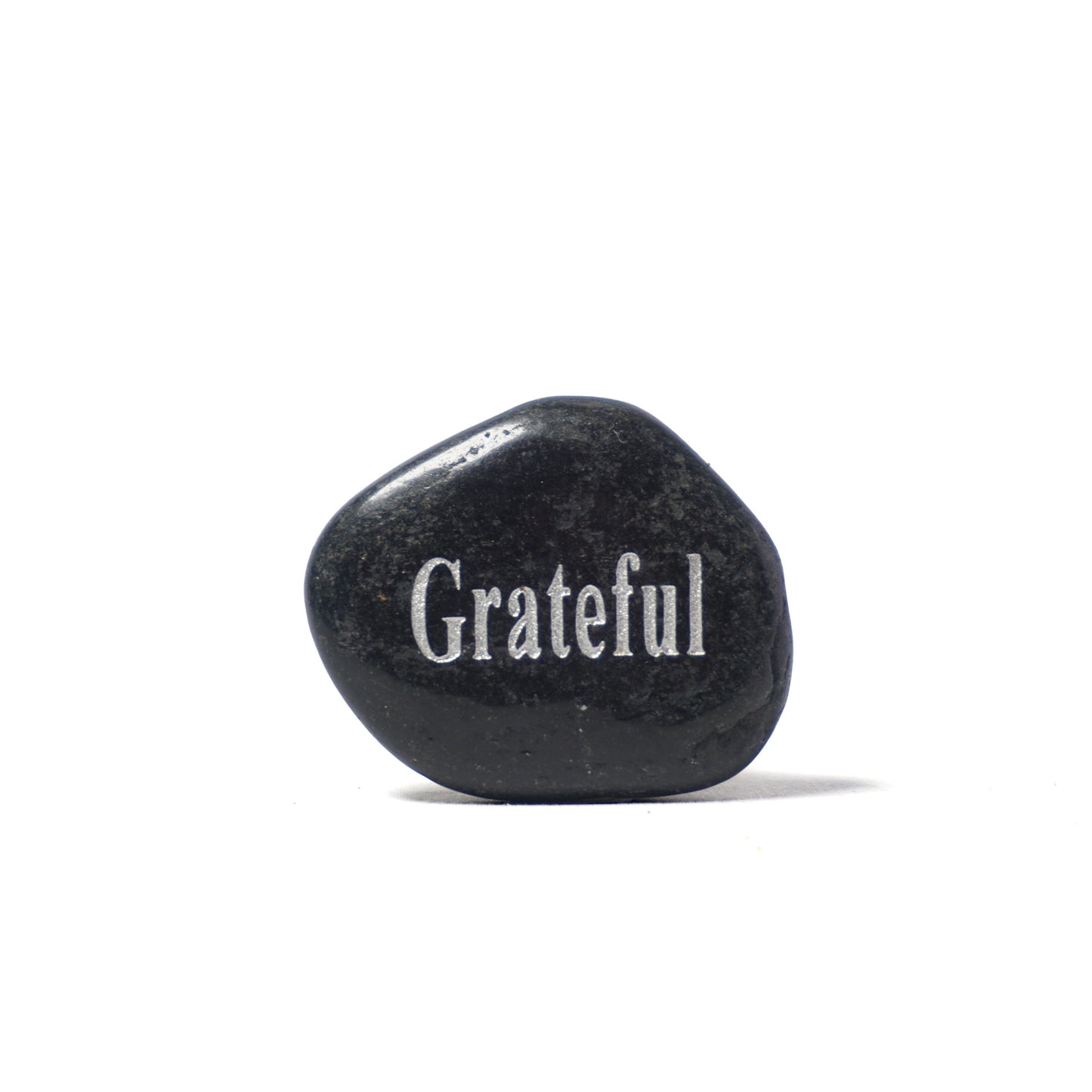 Black stone with 'Grateful' engraved on a white background