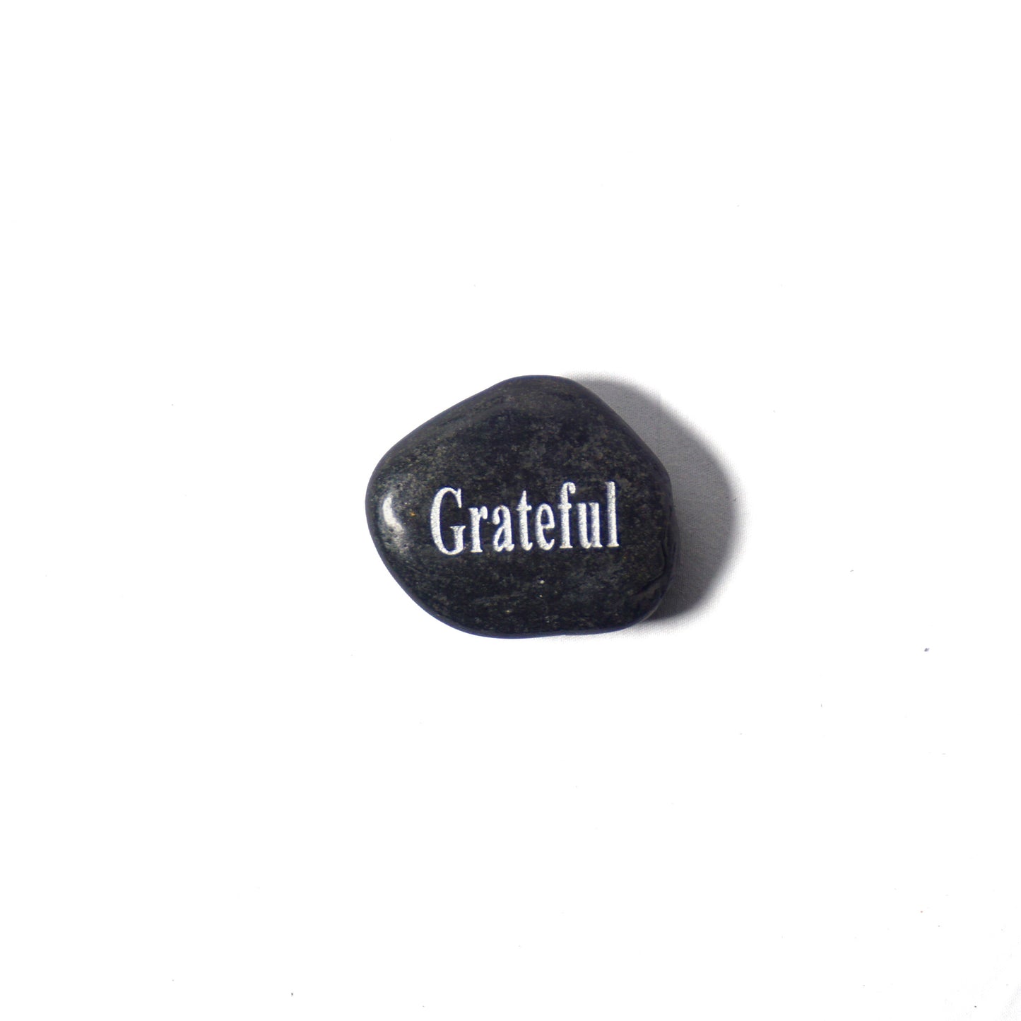 Black stone with 'Grateful' engraved on a white background