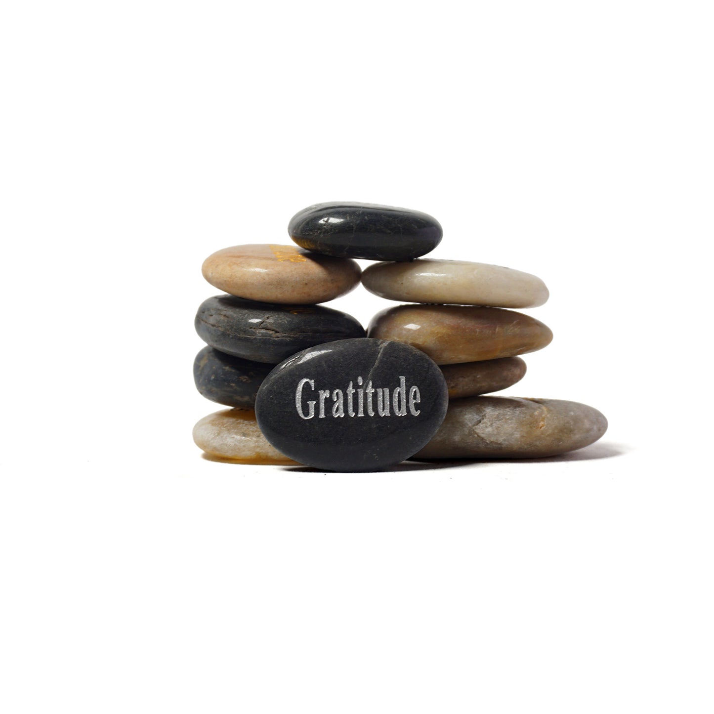 Stack of stones with a engraved 'Gratitude' on a white background