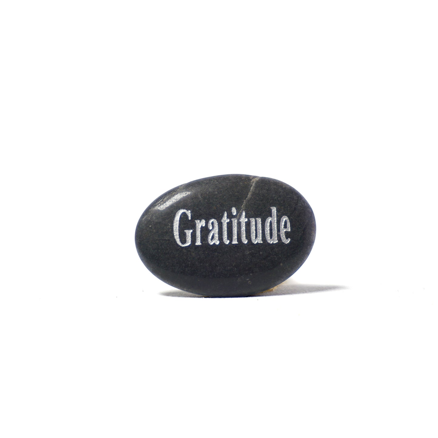 Black stone with 'Gratitude' engraved on a white background