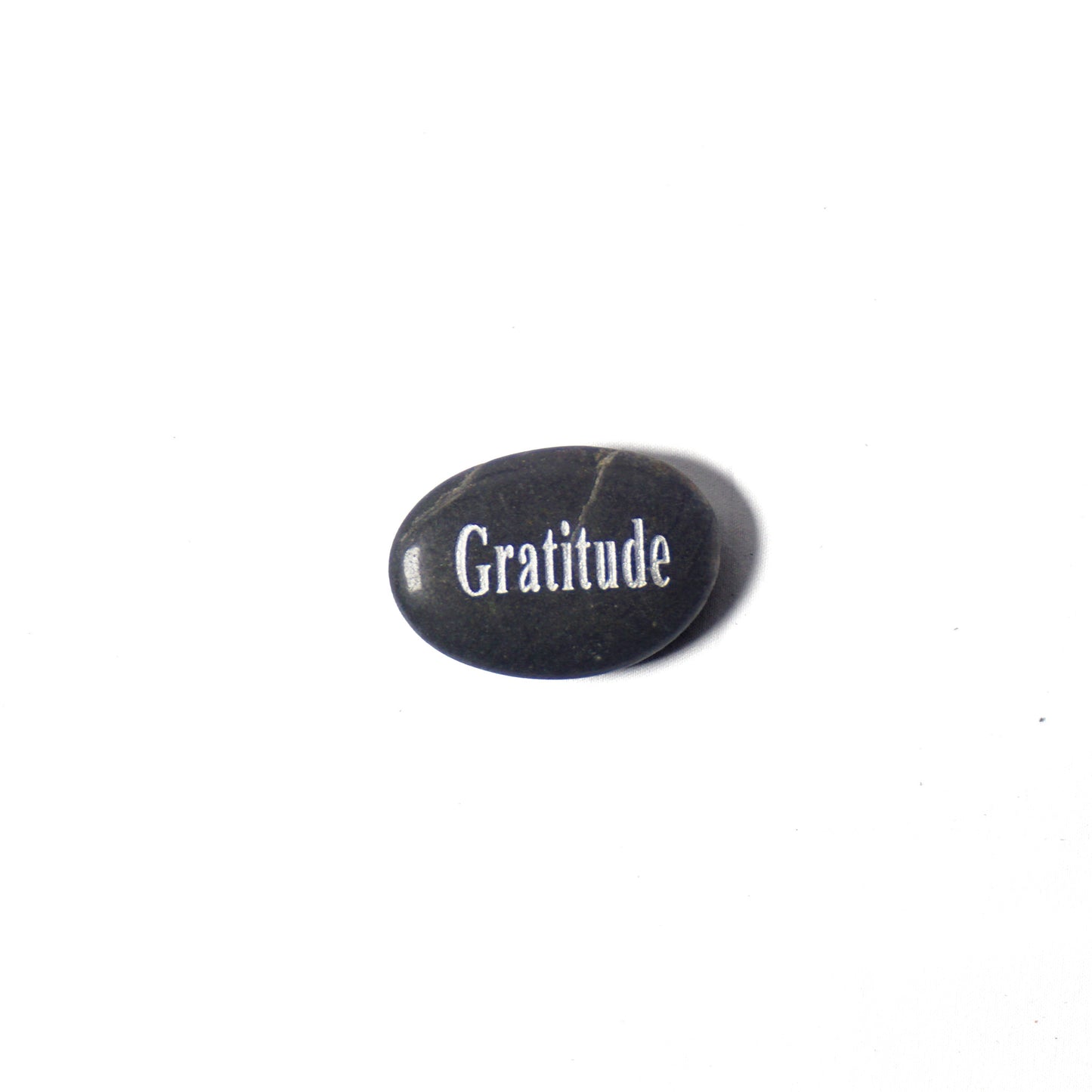 Black stone with 'Gratitude' engraved on a white background