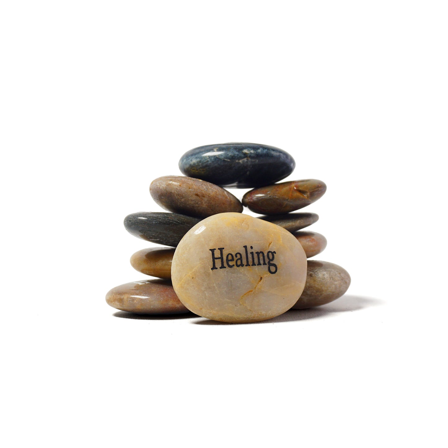 Stack of stones with a prominent stone labeled 'Healing' on a white background