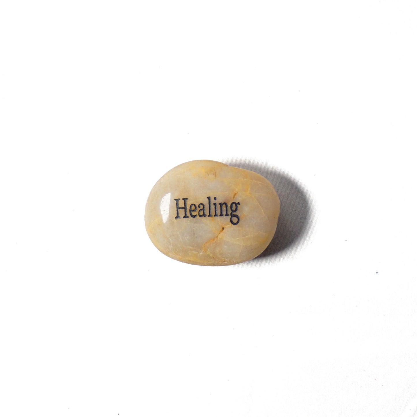 Decorative stone with 'Healing' engraved on a white background