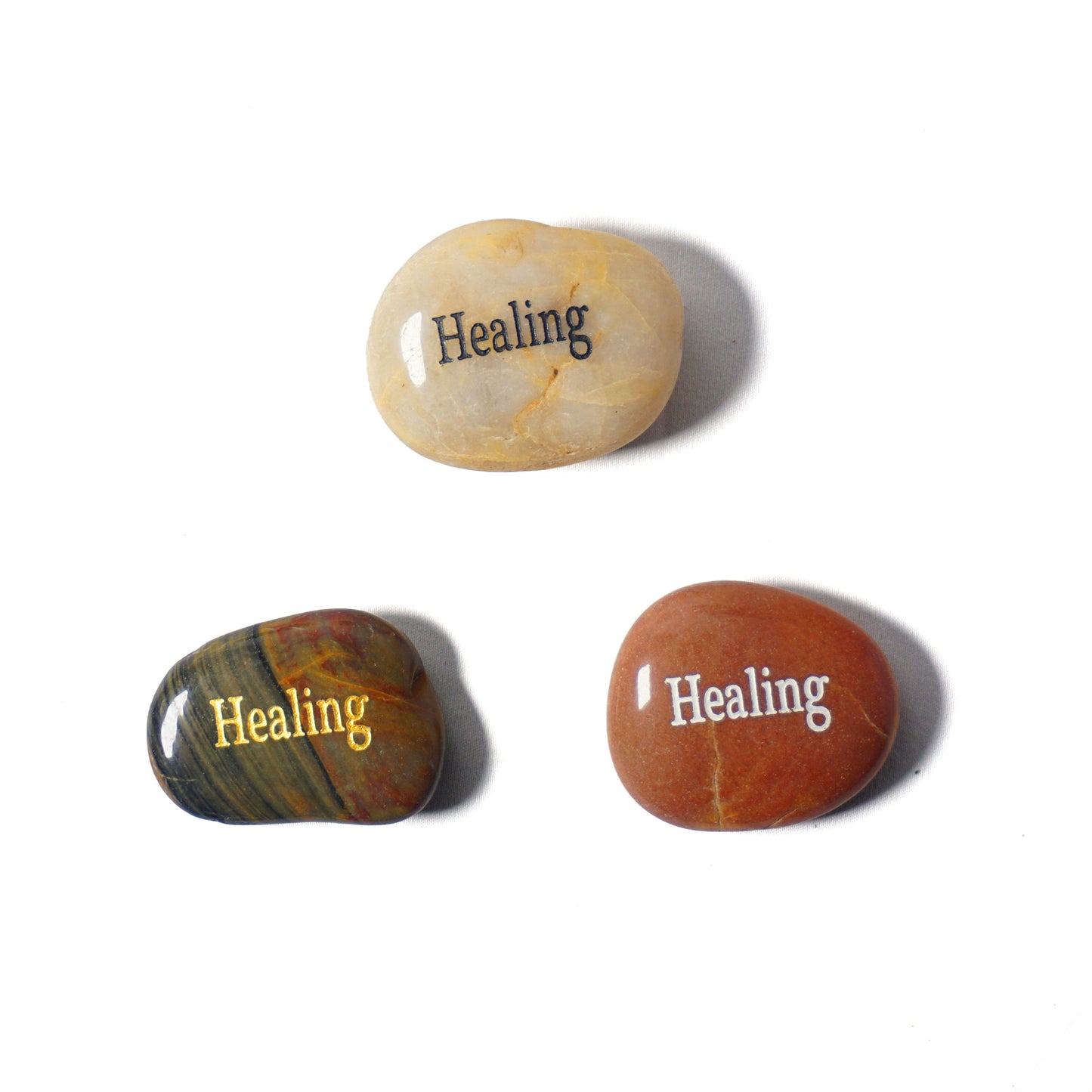 Three stones with 'Healing' text on a white background