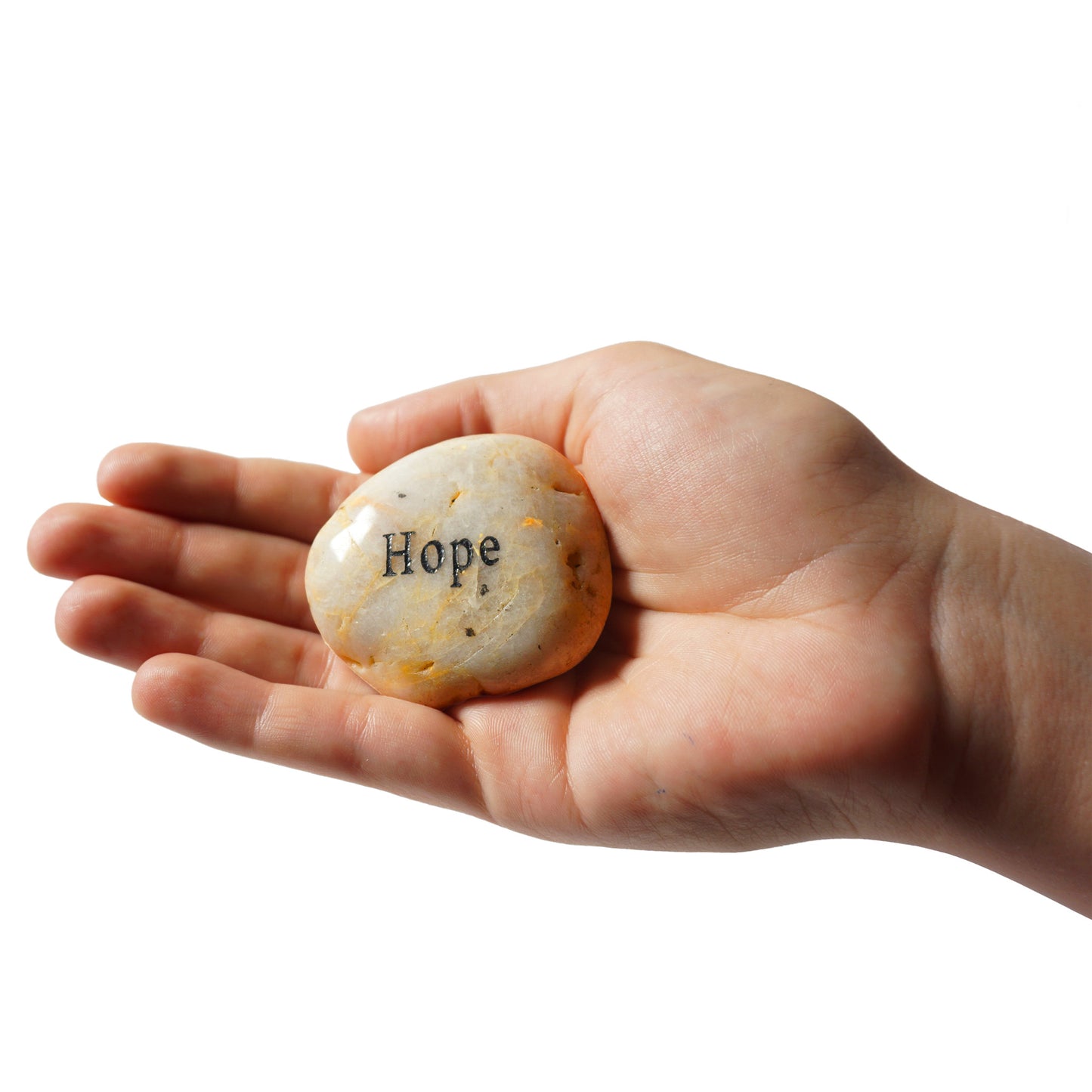 Hand holding a stone with 'Hope' engraved on it against a white background
