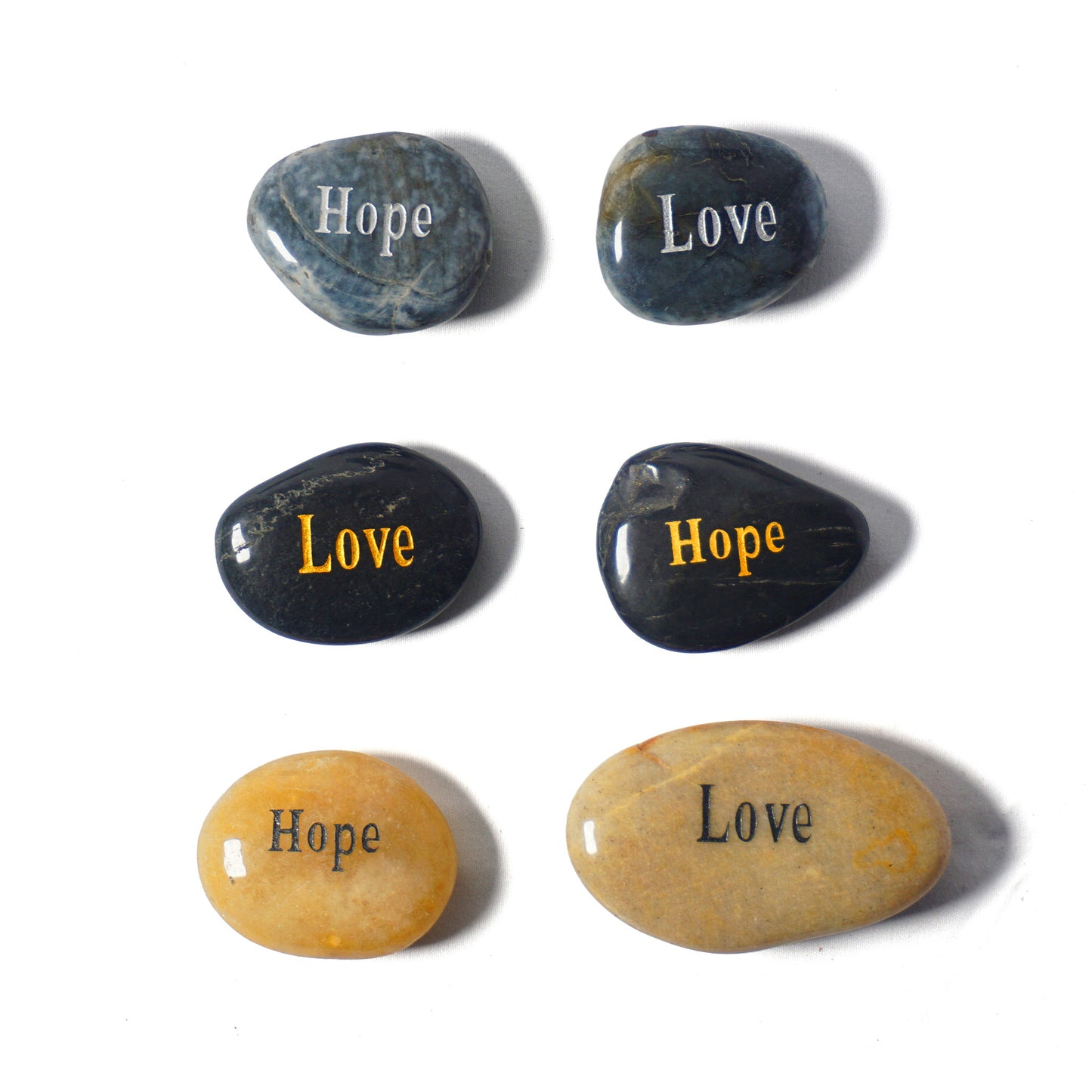 Set of stones with 'Hope' and 'Love' inscribed on them, arranged on a white background.