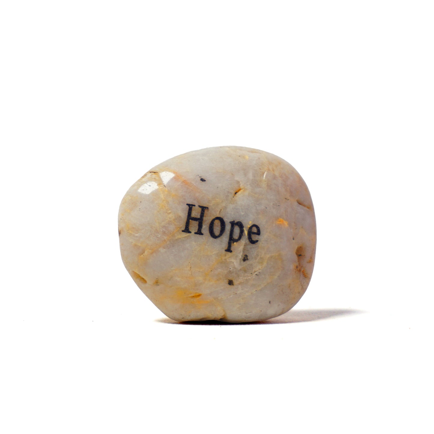 Decorative stone with 'Hope' engraved on a white background