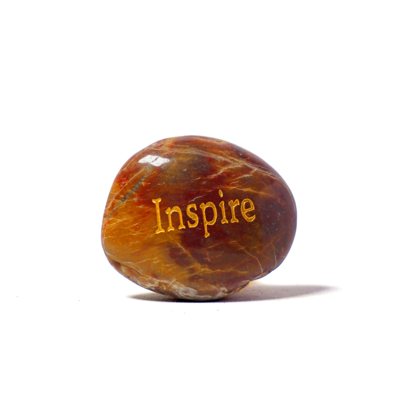 Marbled stone with 'Inspire' engraved on a white background