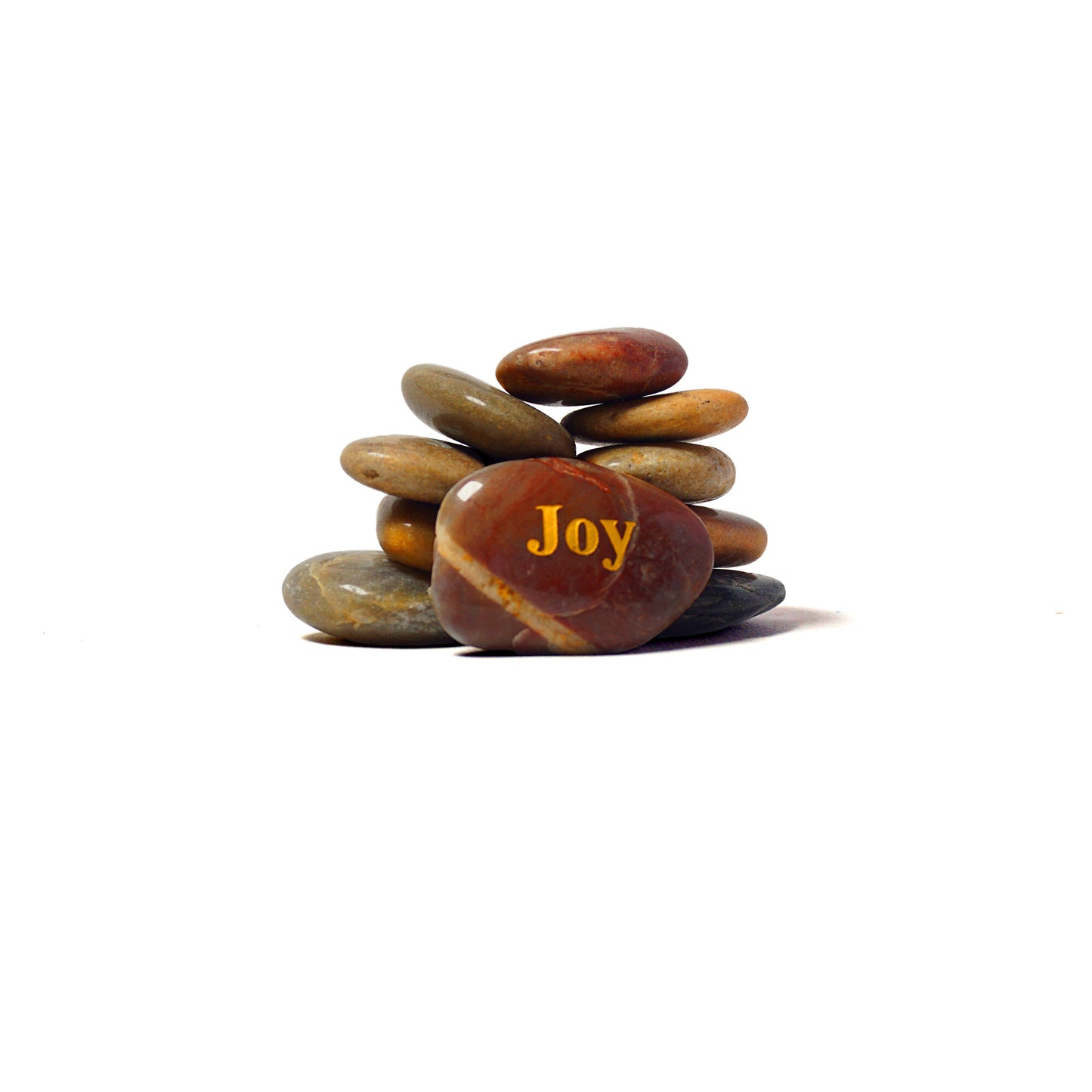 Stack of stones with 'Joy' engraved on a white background