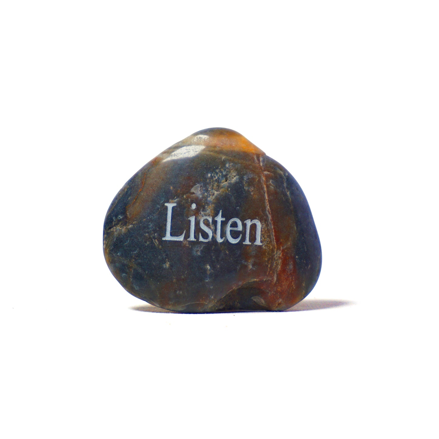 Decorative stone with 'Listen' engraved on a white background