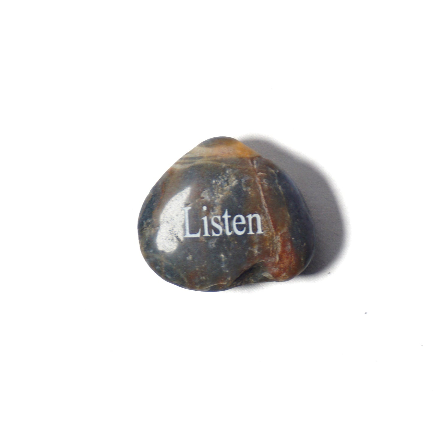 Decorative stone with 'Listen' engraved on a white background
