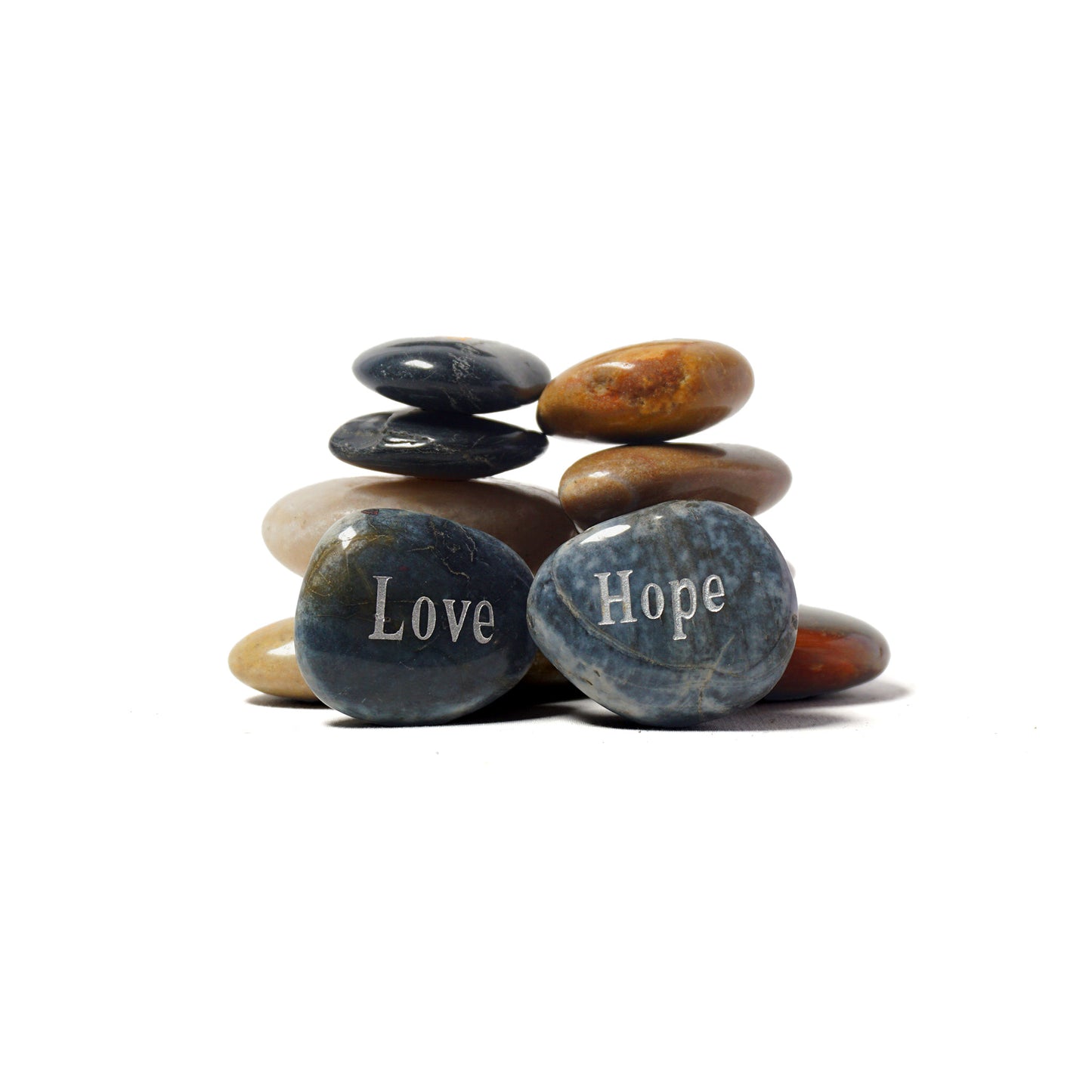 Stack of stones with 'Love' and 'Hope' inscribed on them against a white background
