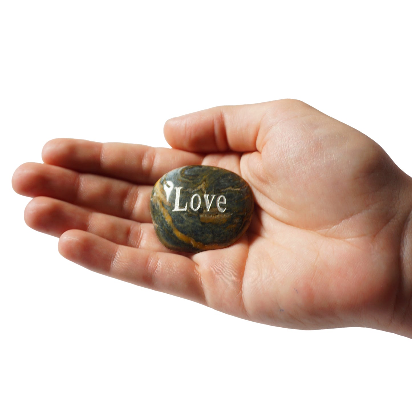 Hand holding a stone with 'Love' engraved on it against a white background