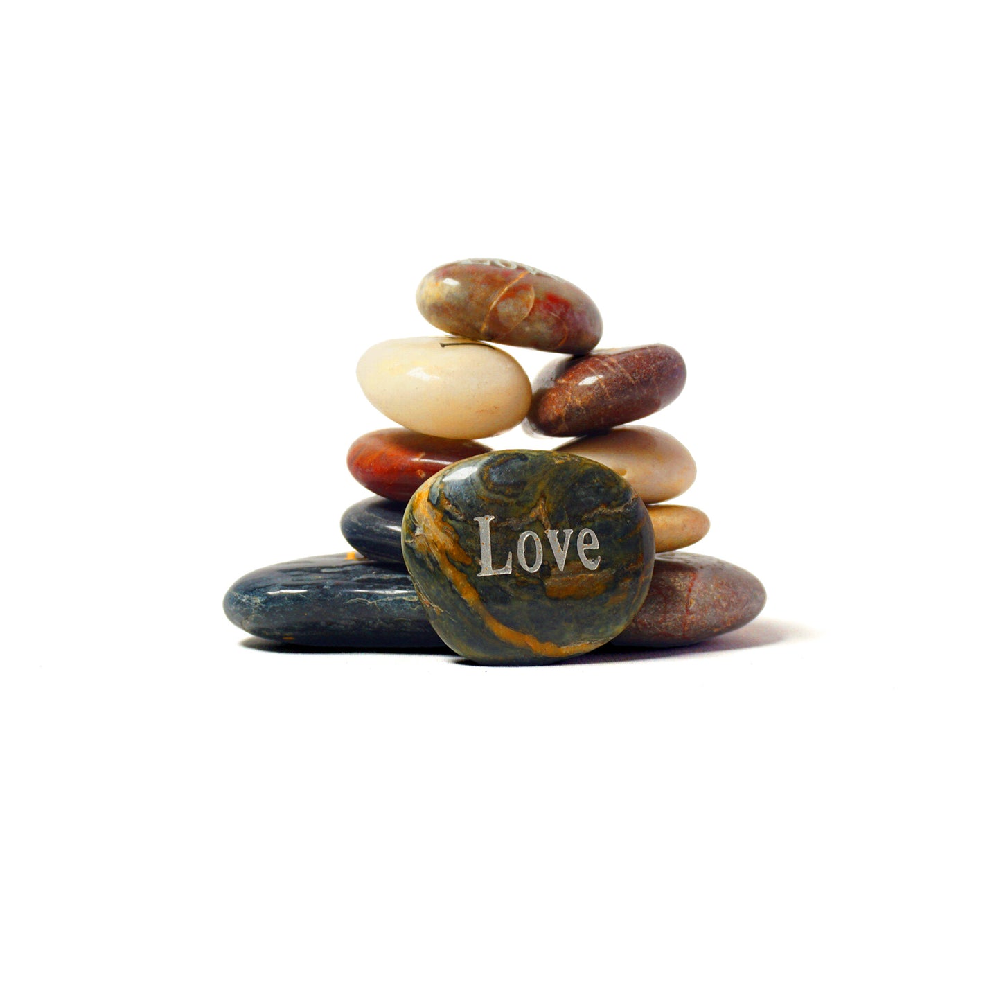 Stack of multicolored stones with 'Love' engraved on a white background