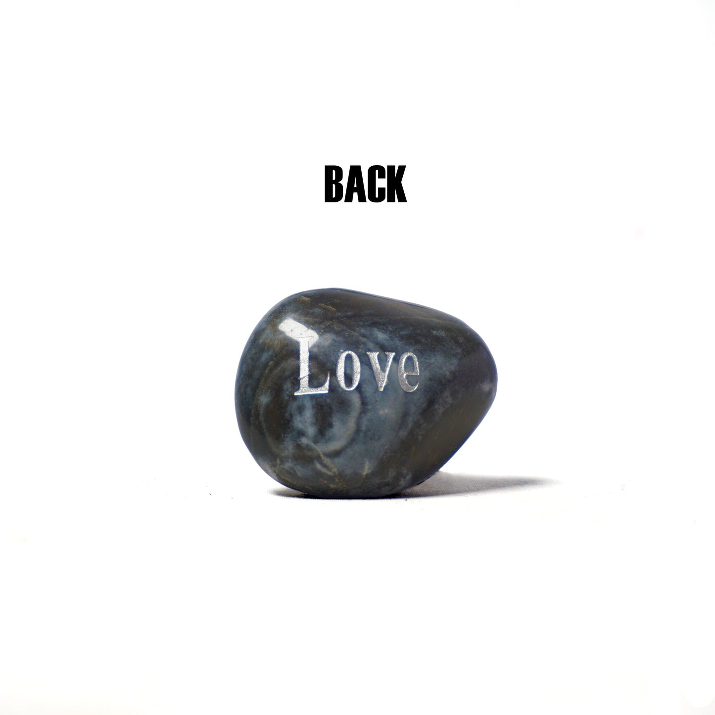 Marble-like stone with 'Love' engraved on a white background