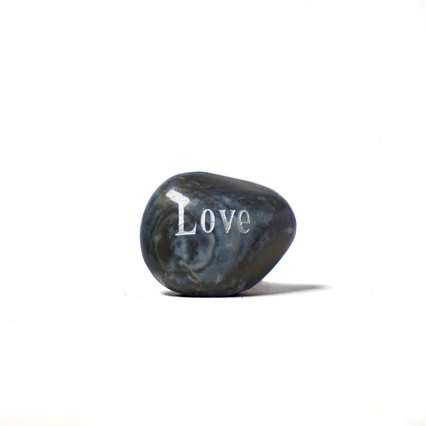 Decorative stone with 'Love' engraved on a white background