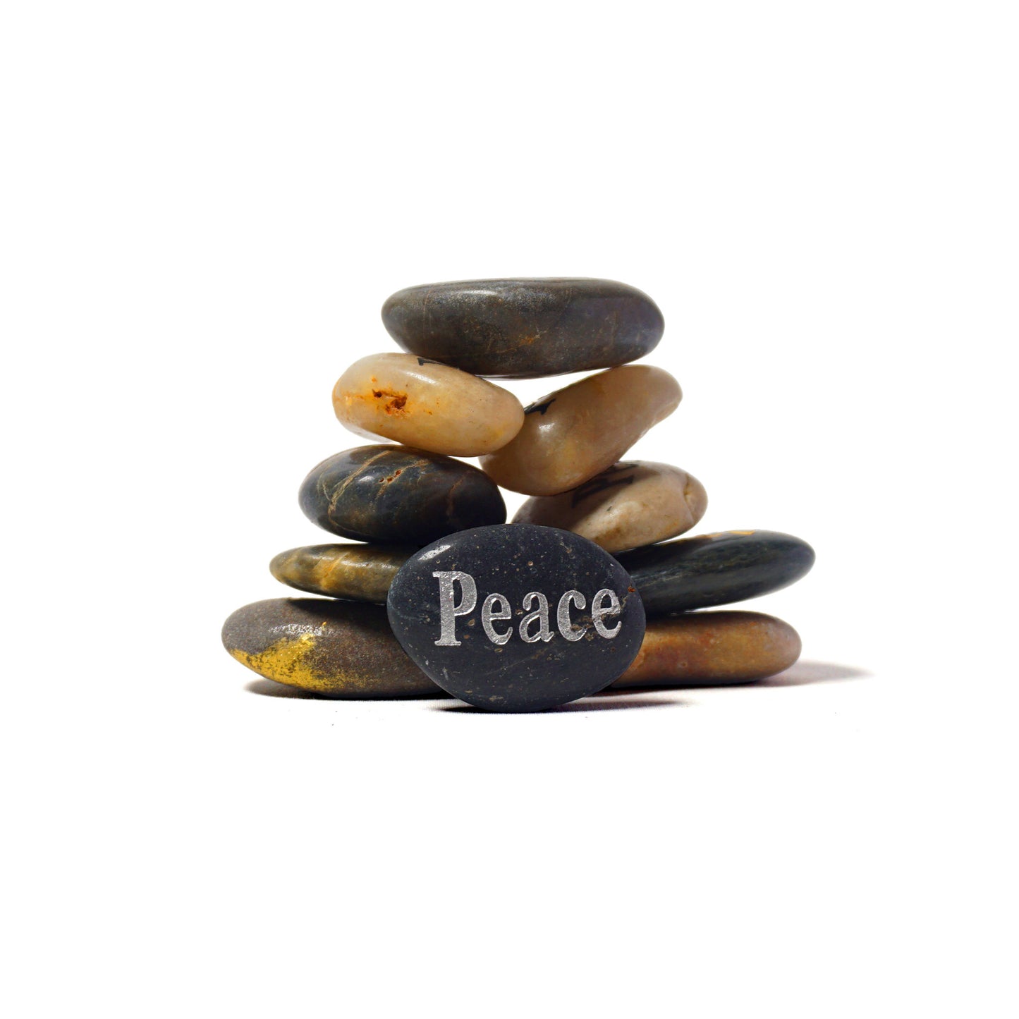 Stack of stones with 'Peace' engraved on a white background