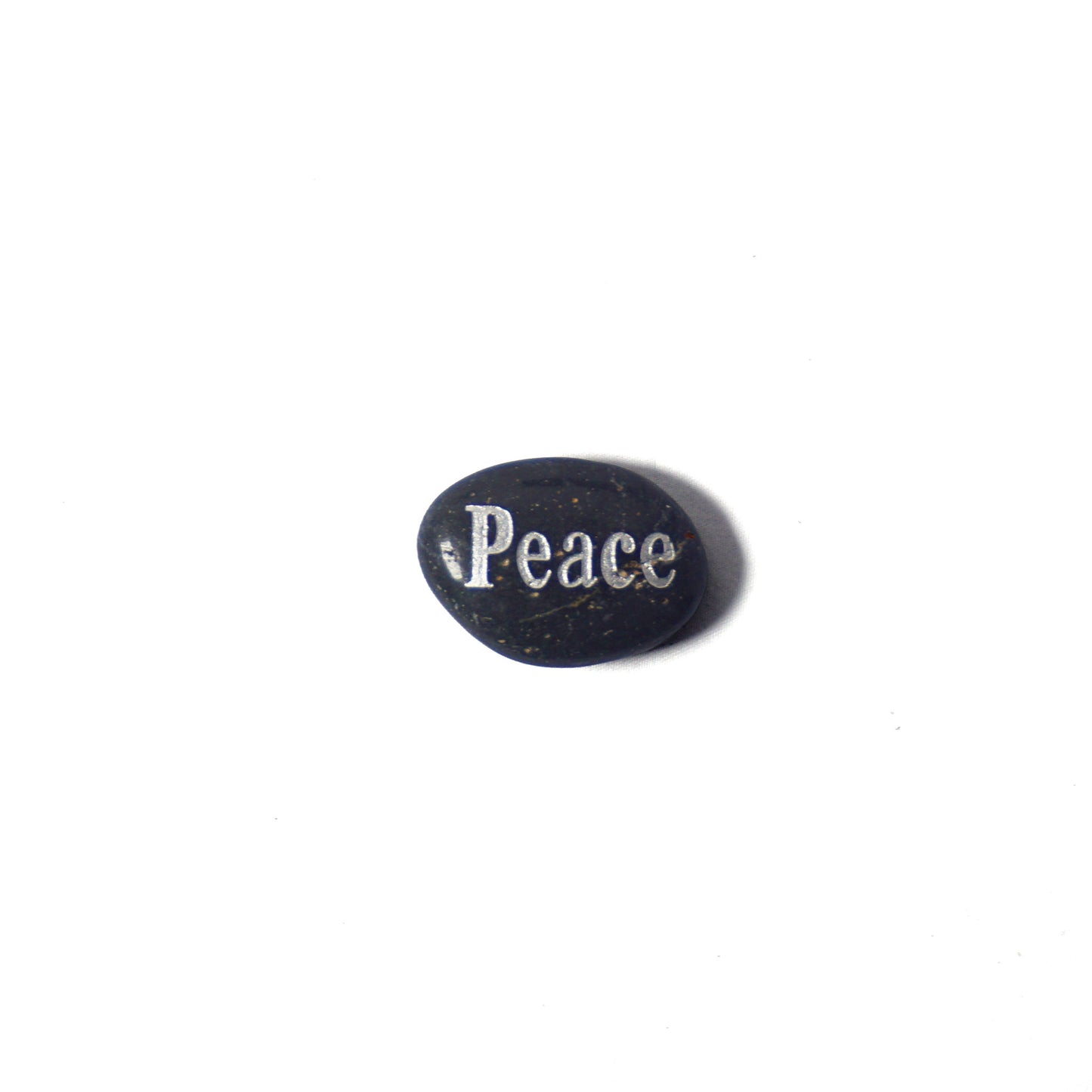 Black oval stone with 'Peace' engraved on a white background