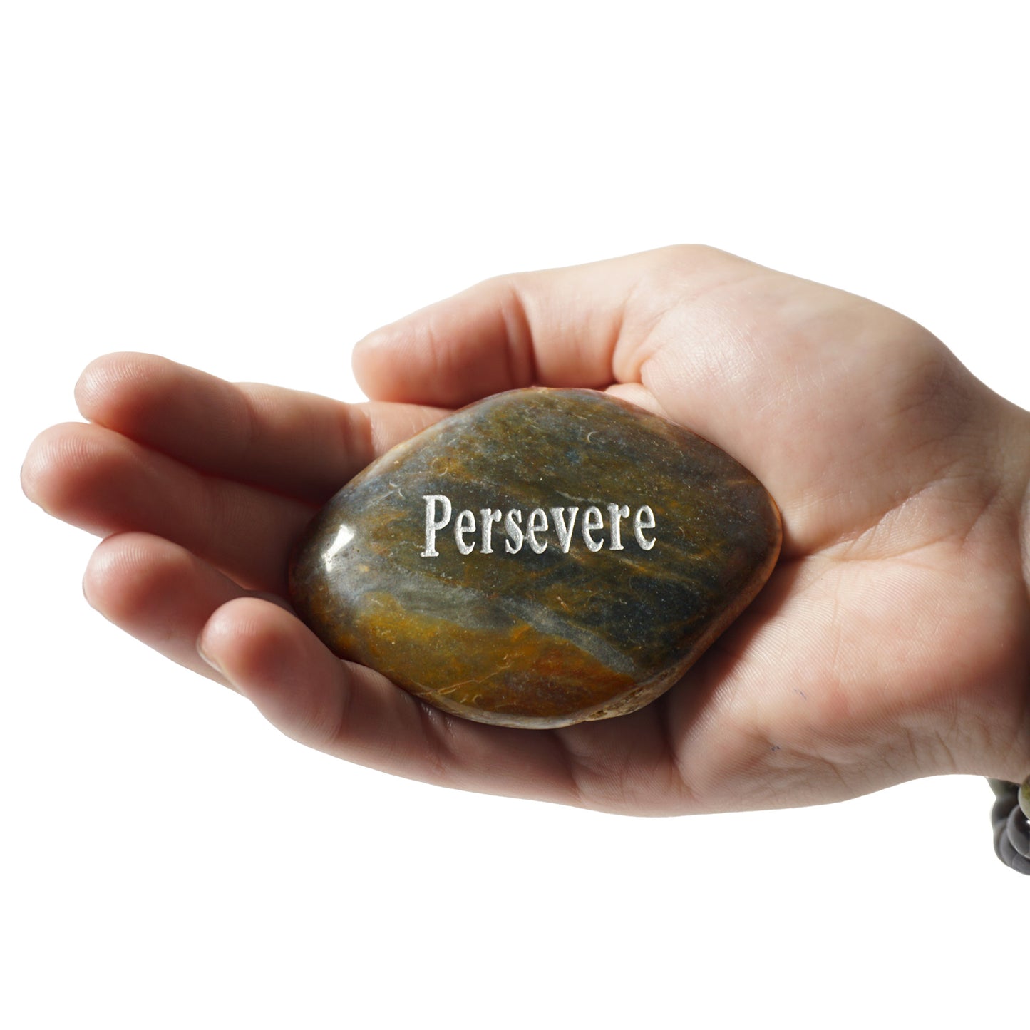 Hand holding a rock with 'Persevere' engraved on it against a white background
